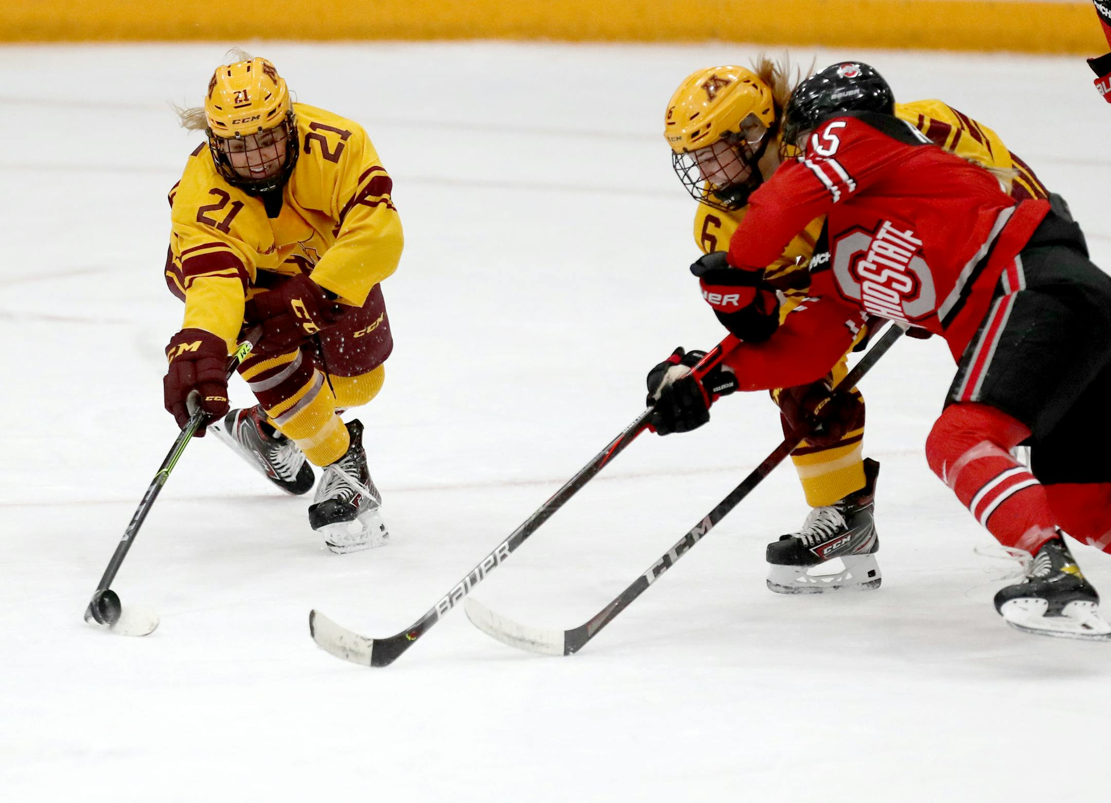 The University of Minnesota Gopher's Emily Oden (21) and Gracie Ostertag (6) battle for a loose puck with Ohio State's Gabby Rosenthal during the 1st period in Minneapolis. ] DAVID JOLES • david.joles@startribune.com Sunday, Nov. 22, 2020 in Minneapolis MN Gopher's women hockey vs. Ohio State Sunday at Ridder Arena in Minneapolis