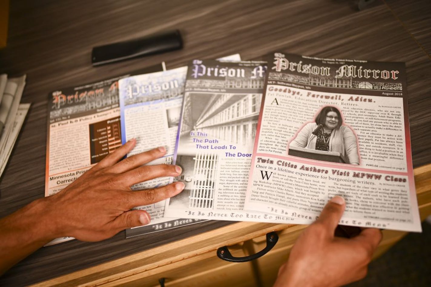 Jeffery Young, an inmate at Stillwater Correctional Facility and editor for the Prison Mirror, showed some recent editions of the paper Wednesday in the paper's newsroom.