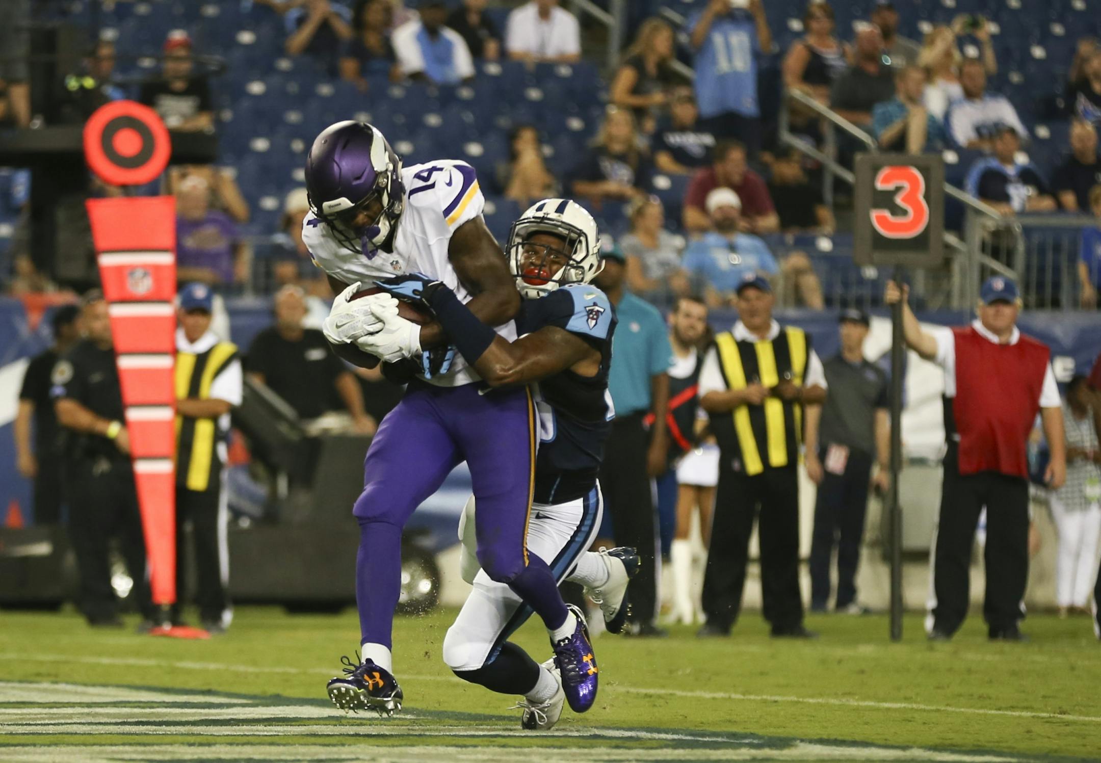 Vikings wide receiver Stefon Diggs (14) was tackled in the end zone by Titans defensive back Ri'Shard Anderson (38) after his 7 yard touchdown reception in the fourth quarter Thursday night.