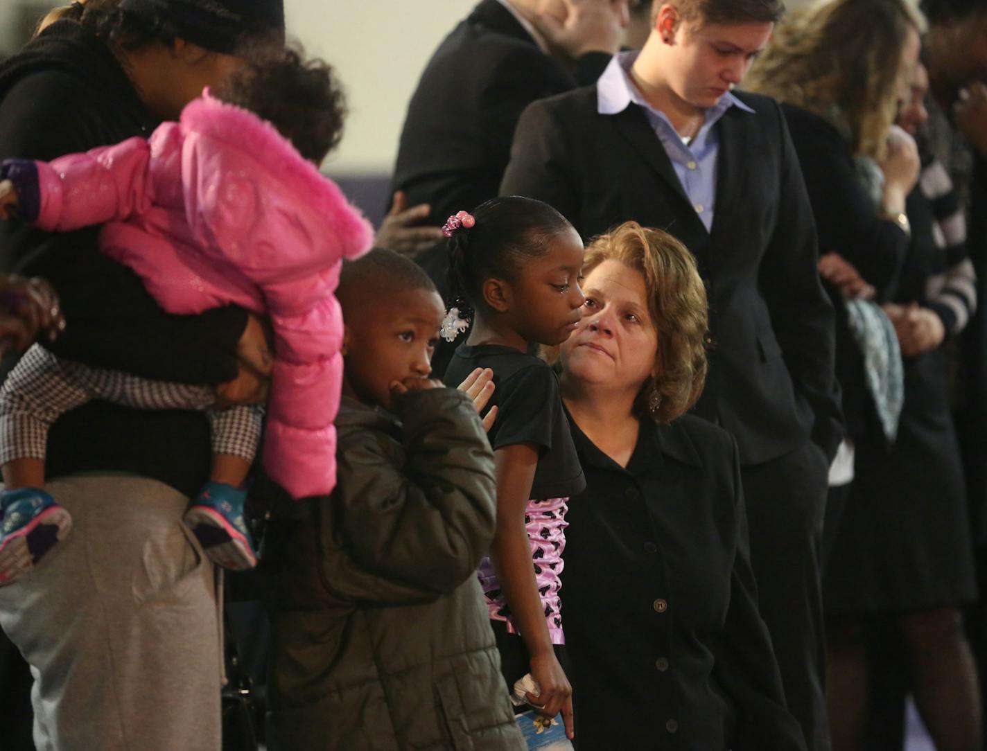 Teachers and friends comforted each other as they viewed the Lewis' caskets before the funeral. ] (KYNDELL HARKNESS/STAR TRIBUNE) kyndell.harkness@startribune.com During the funeral for the five Lewis children who died in a fire on Valentine's Day at Shiloh Temple Church in Minneapolis Saturday, March 1 2014.