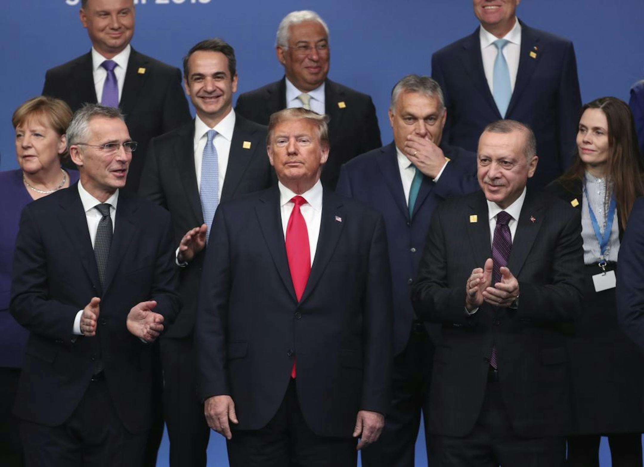 NATO leaders from front left, German Chancellor Angela Merkel, NATO Secretary General Jens Stoltenberg, U.S. President Donald Trump, Hungarian Prime Minister Viktor Orban, Turkish President Recep Tayyip Erdogan and Iceland's Prime Minister Katrin Jakobsdottir attend a ceremony event during a NATO leaders meeting at The Grove hotel and resort in Watford, Hertfordshire, England, Wednesday, Dec. 4, 2019. NATO Secretary-General Jens Stoltenberg rejected Wednesday French criticism that the military a