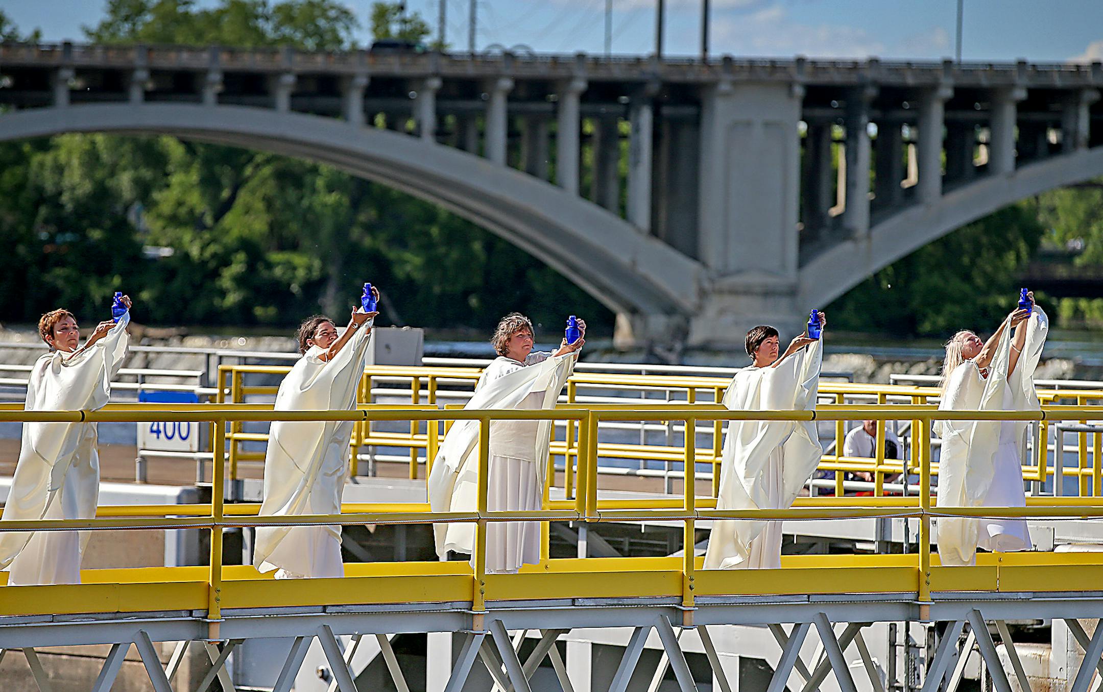 Women of the Waters performed a routine atop the lock and dam during the Solstice River XIX & Global Water Dances, Saturday, June 20, 2015 in Minneapolis, MN. ] (ELIZABETH FLORES/STAR TRIBUNE) ELIZABETH FLORES • eflores@startribune.com
