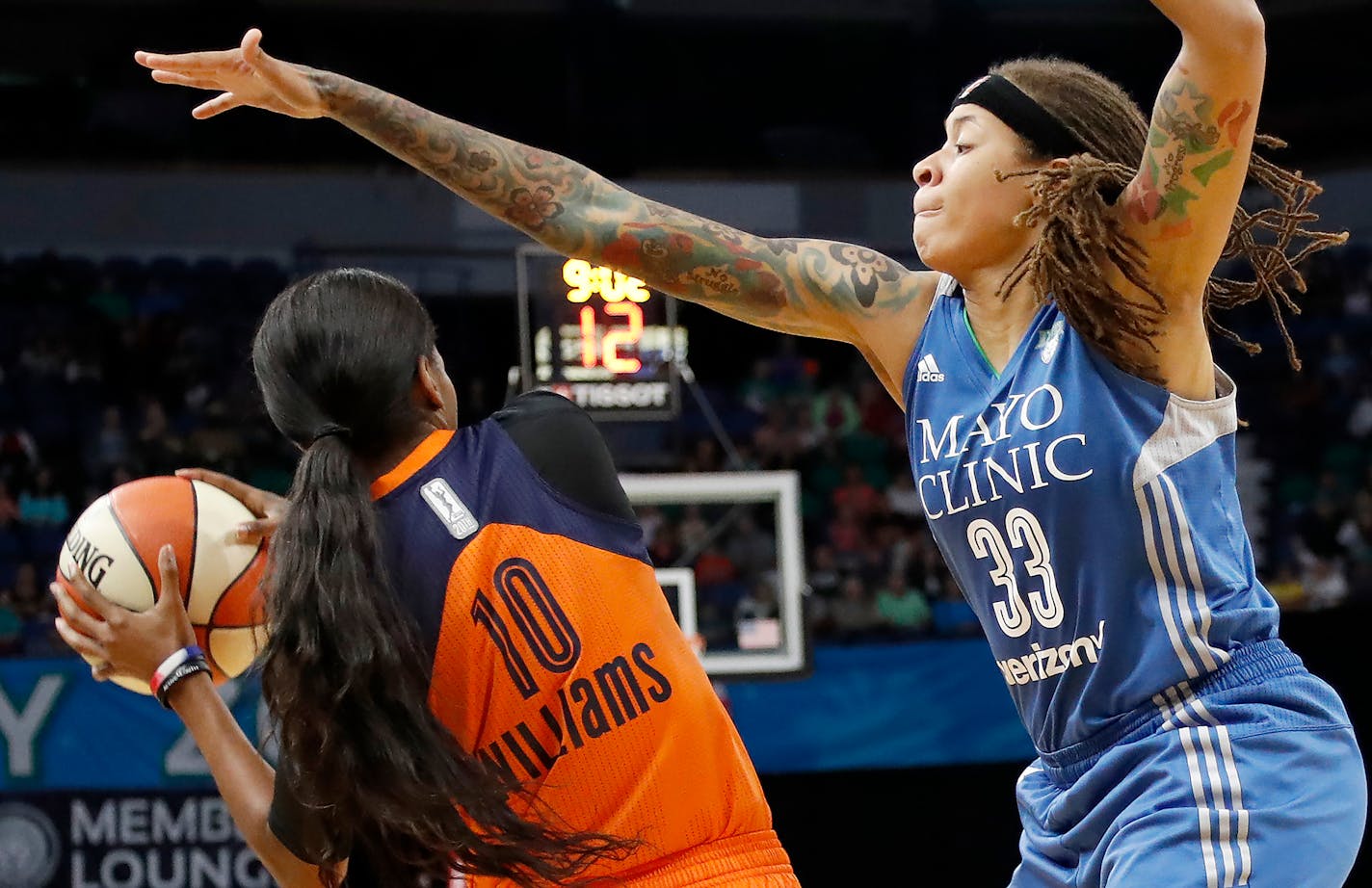 Connecticut's Courtney Williams was defended by Lynx guard Seimone Augustus in the second quarter Sunday at Target Center.