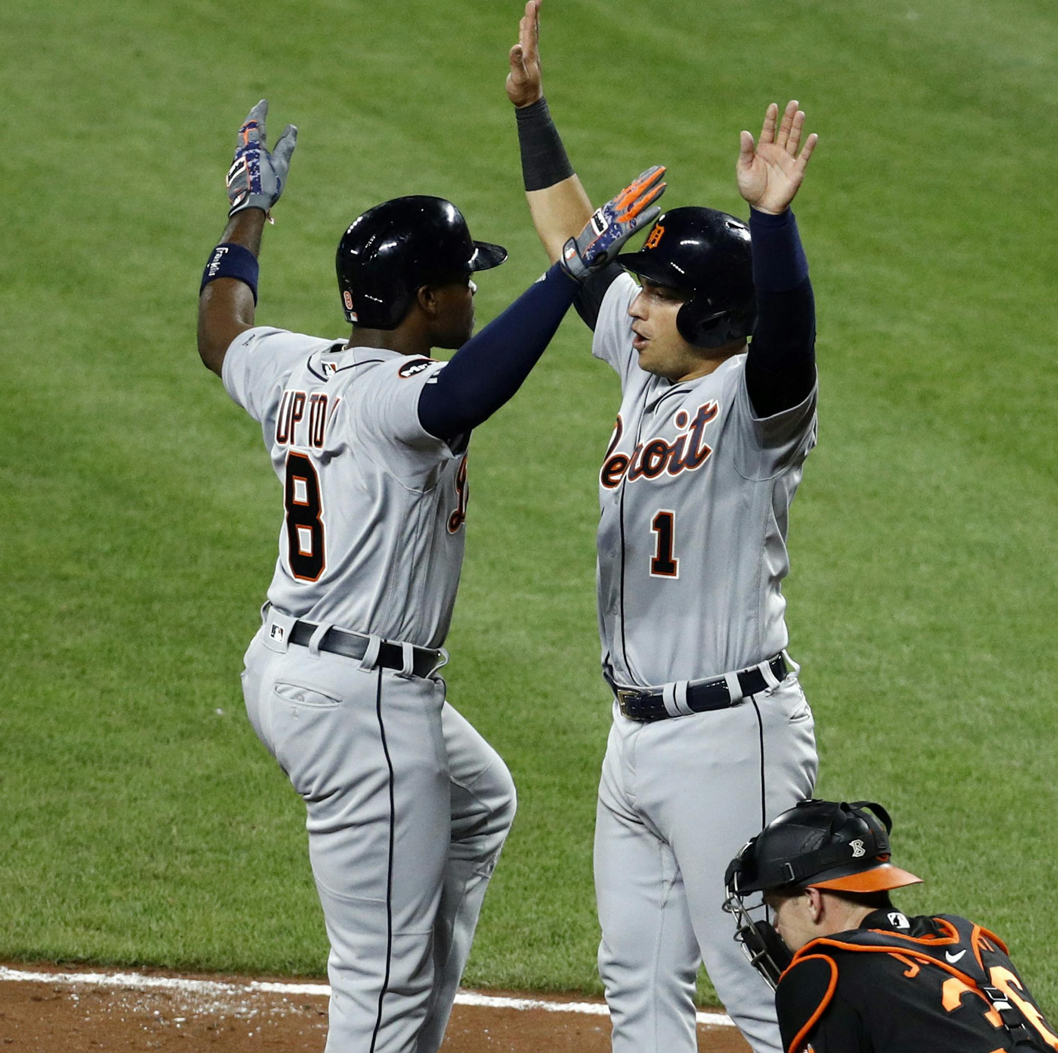 Detroit Tigers' Justin Upton (8) celebrates his grand slam with teammates Jose Iglesias (1), Miguel Cabrera (24), Jim Adduci, second from right, and Andrew Romine (17) in front of Baltimore Orioles catcher Caleb Joseph in the eighth inning of a baseball game in Baltimore, Friday, Aug. 4, 2017. (AP Photo/Patrick Semansky)