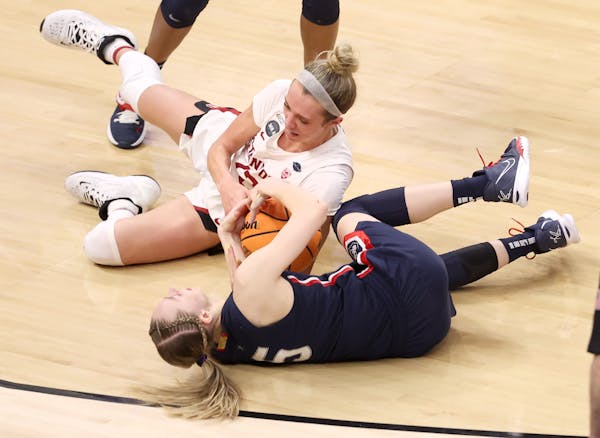 Paige Bueckers and Ashten Prechtel (11) of Stanford fight for the ball in the fourth quarter.