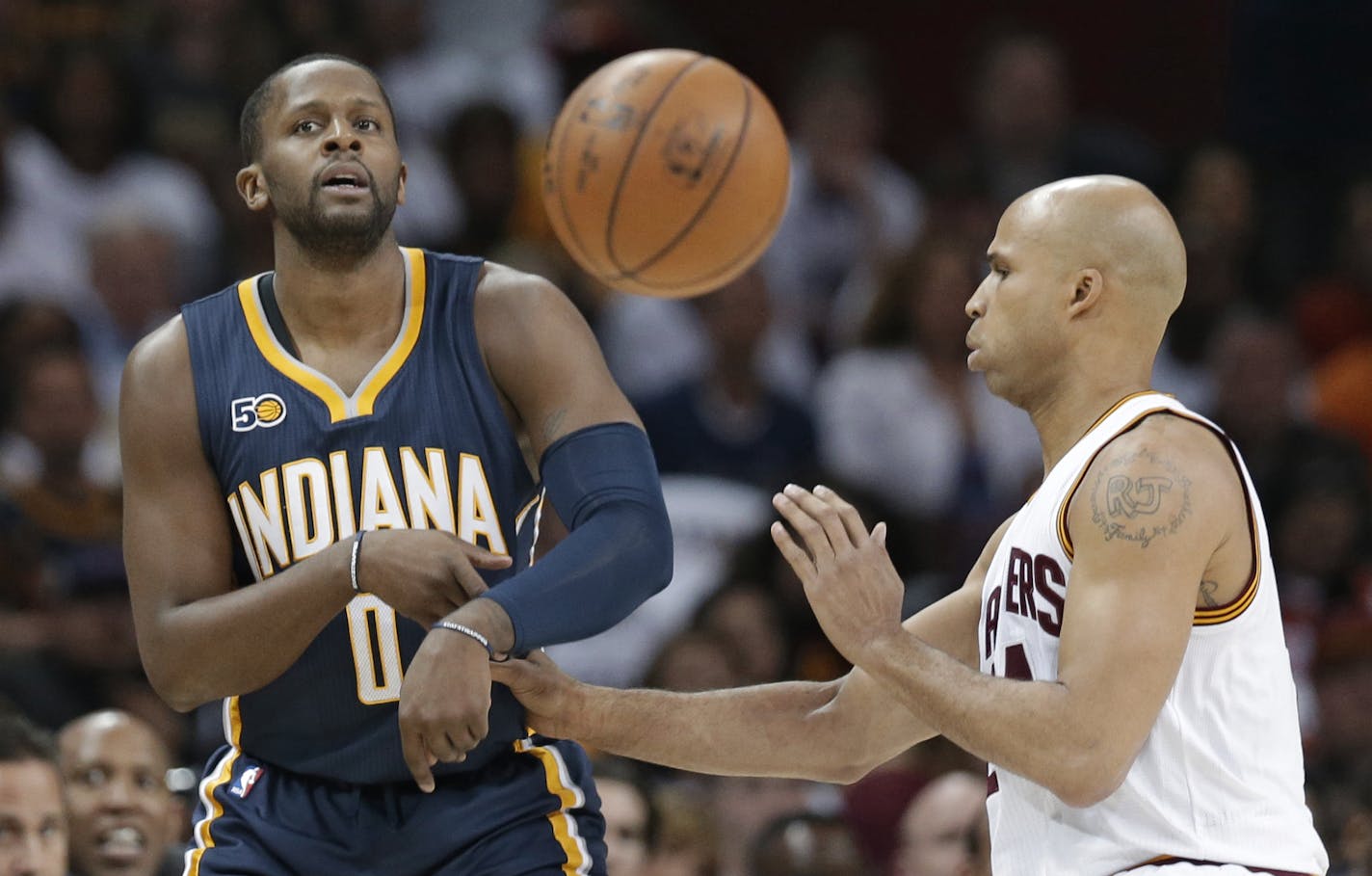 Indiana Pacers' C.J. Miles (0) passes agasint Cleveland Cavaliers' Richard Jefferson (24) in the first half in Game 2 of a first-round NBA basketball playoff series, Monday, April 17, 2017, in Cleveland. (AP Photo/Tony Dejak) ORG XMIT: OHTD10