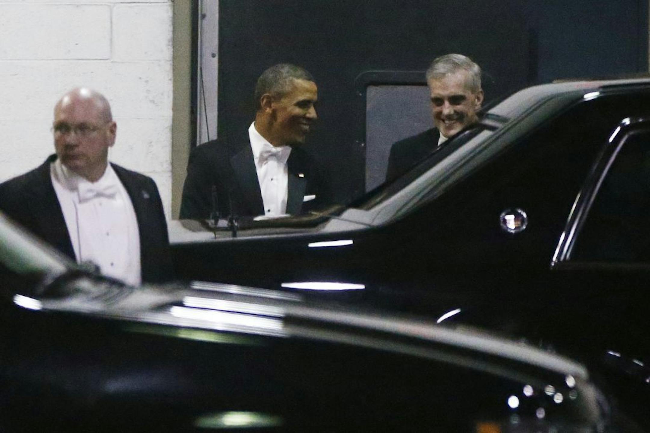 President Barack Obama walks with Chief of Staff Denis McDonough, right, as they leave the Gridiron Dinner through a loading area at a hotel in Washington, Saturday, March 9, 2013.