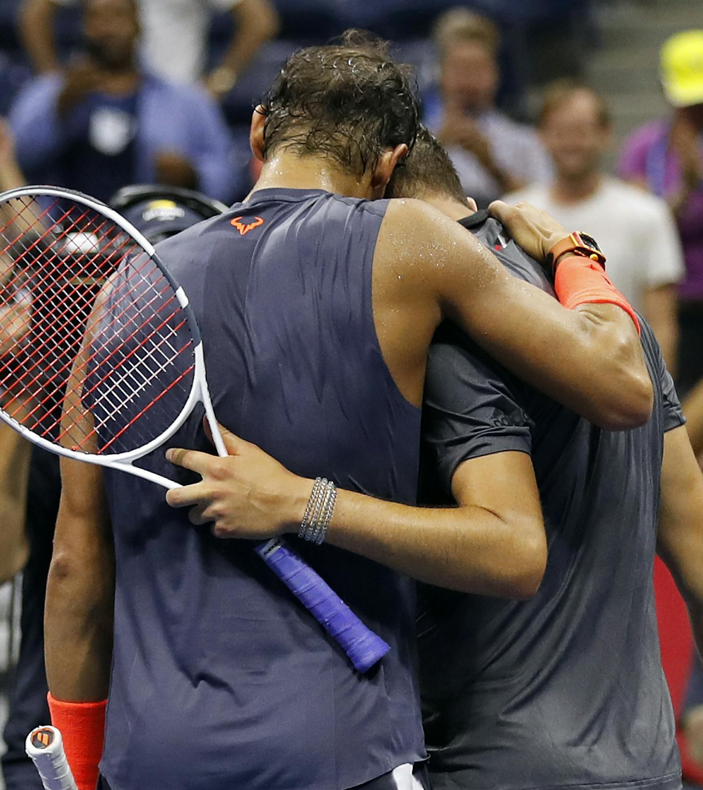 Rafael Nadal, left, of Spain, embraces Dominic Thiem, of Austria, after winning their match during the quarterfinals of the U.S. Open tennis tournament, early Wednesday, Sept. 5, 2018, in New York. (AP Photo/Adam Hunger)