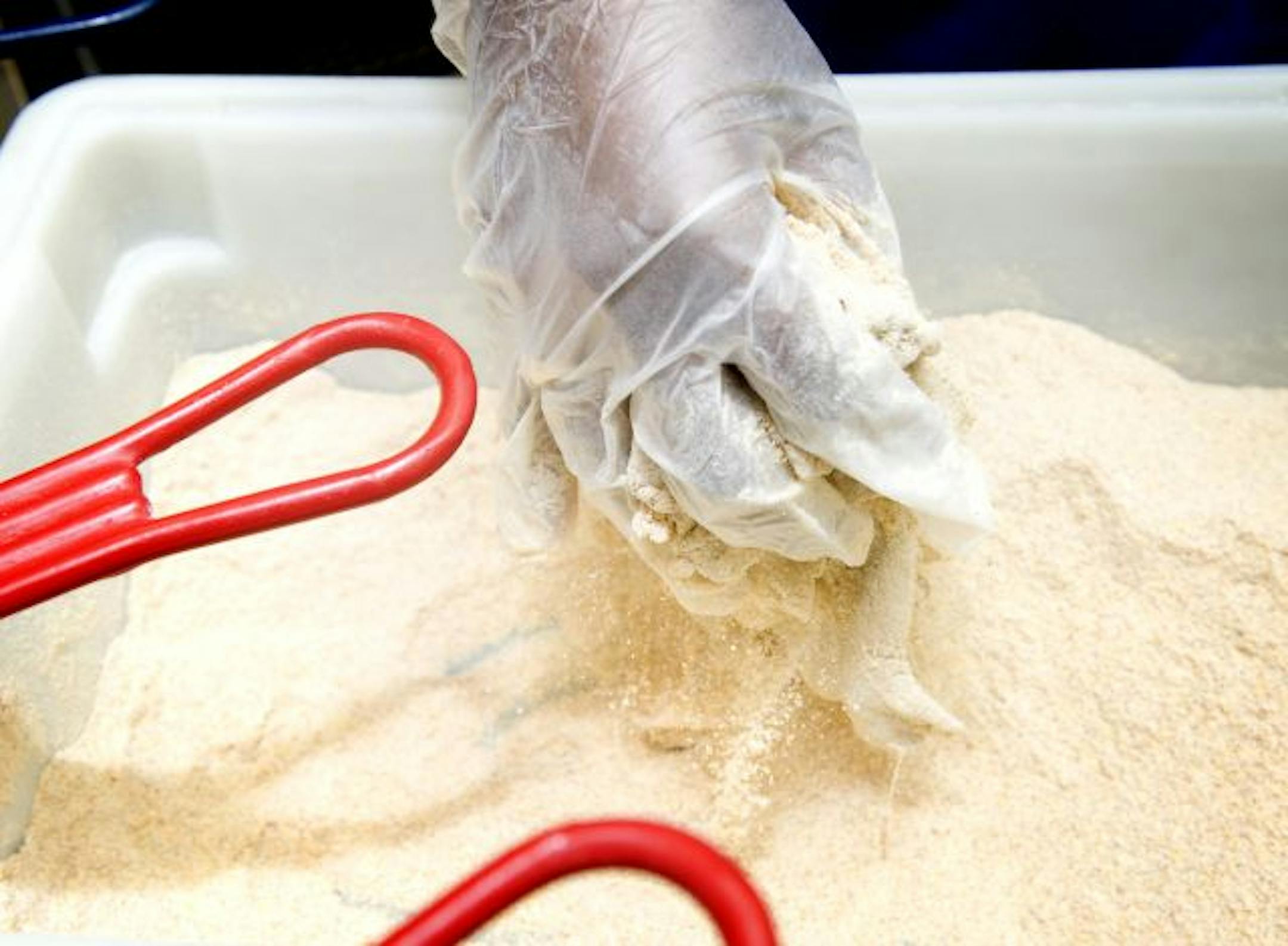 Sharon El-Amin stirred the ingredients for catfish nuggets.