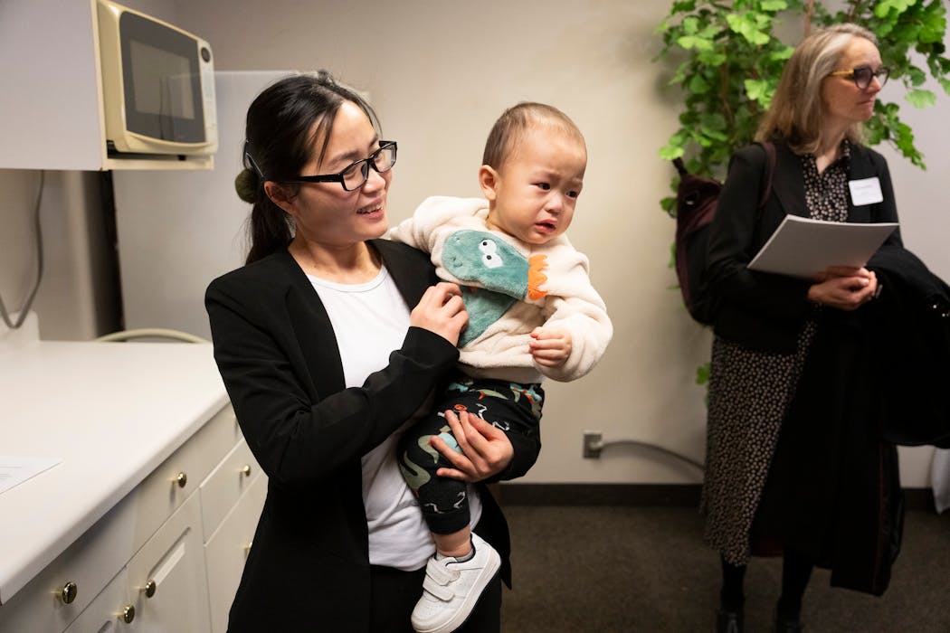 Xee Her, who uses WIC and has become a peer breastfeeding councilor, holds her 15-month-old son Brady Le after a press conference at the Ramsey County WIC Office with U.S. Agriculture Secretary Tom Vilsack who came to express support for funding for the program on Thursday.