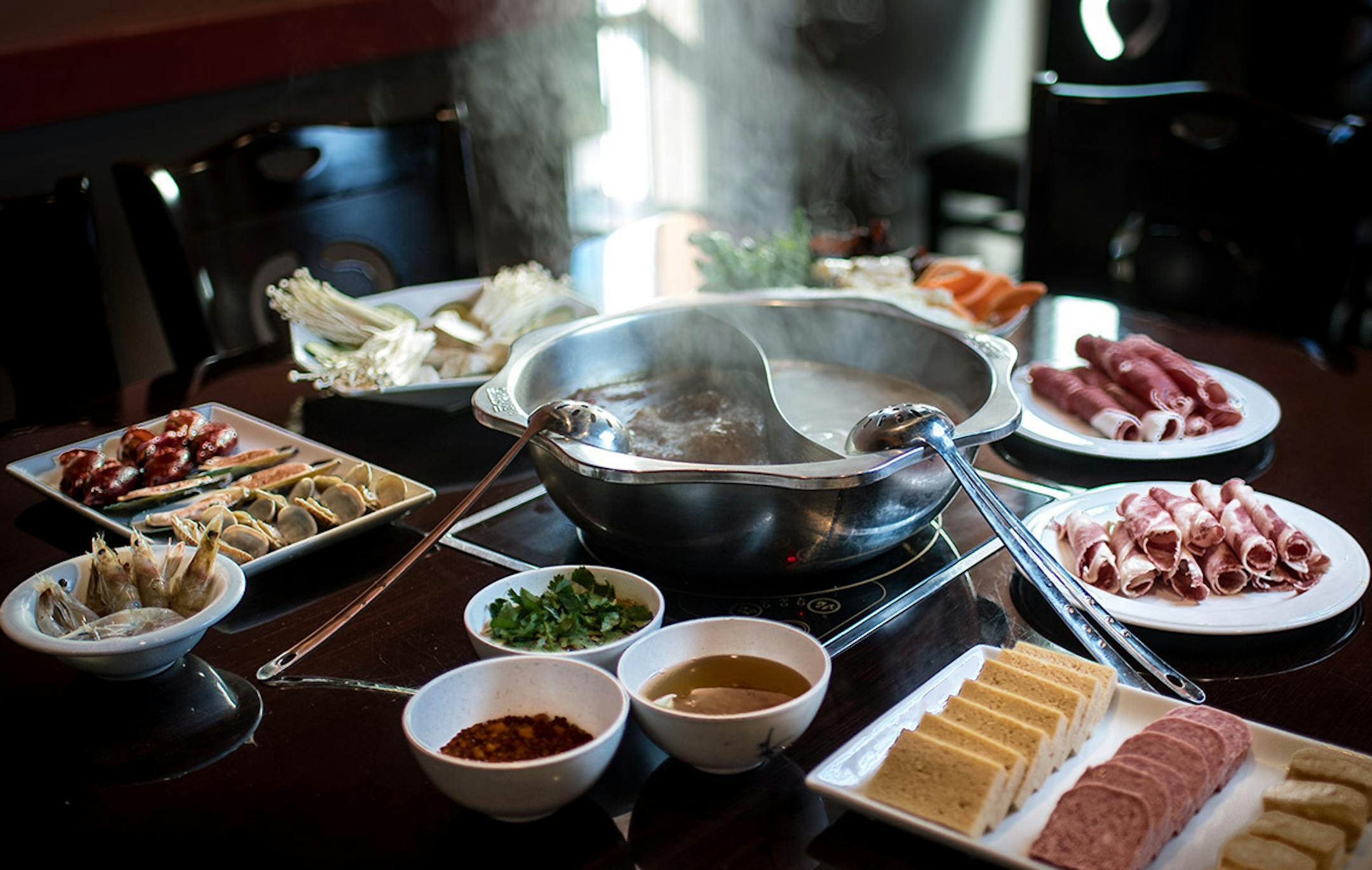 Little Szechuan's Hot Pot with sirloin beef slices, lamb slices, luncheon meat, shrimp, mussels, clams, fish tofu, Chinese cabbage, watercress, yams, winter melon, king oyster mushrooms, enoki mushrooms, wood ear mushrooms, frozen tofu, potato sticks and chicken gizzards.