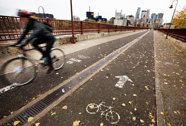 A bicyclist cruises over the Stone Arch Bridge in downtown Minneapolis.