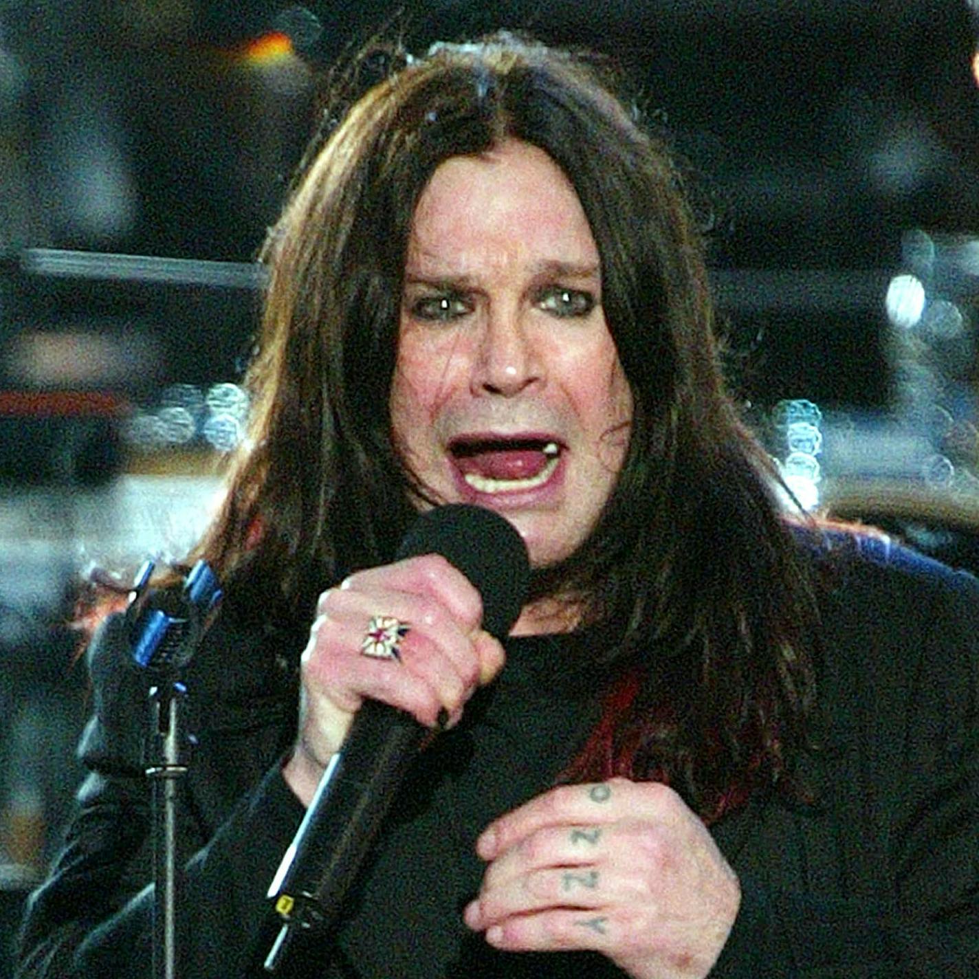 ** FILE ** Ozzy Osbourne performs at the Golden Jubilee pop concert in the gardens of Buckingham Palace in London in this June 3, 2002 file photo. Osbourne's going back to Ozzfest sooner than expected. Osbourne left the 2002 tour to be with his wife, Sharon, while she has chemotherapy treatments for cancer that she recently learned had spread beyond her colon. He had been expected to rejoin the tour on Aug. 22 in Denver. (AP Photo/Stephen Hird, File) ORG XMIT: MIN2013071513591236