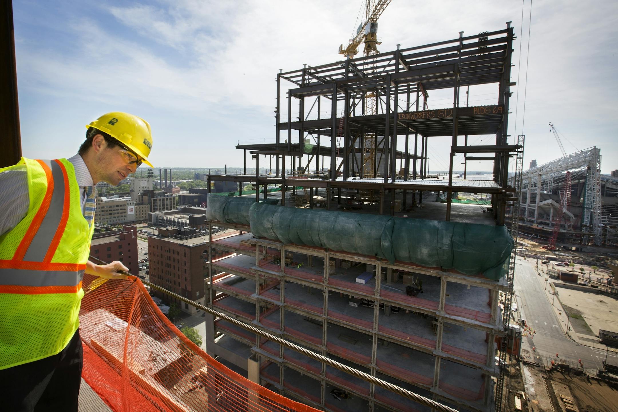 Minneapolis city councilman Jacob Frey takes in the view from the 15th floor of one of the Wells Fargo towers during a topping off ceremony for the Wells Fargo towers by Ryan Companies in Minneapolis on Tuesday, June 2, 2015.