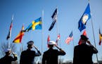 Leadership representing Norfolk-based NATO headquarters salute as the Swedish flag is raised outside of NATO Allied Command Transformation in Norfolk,