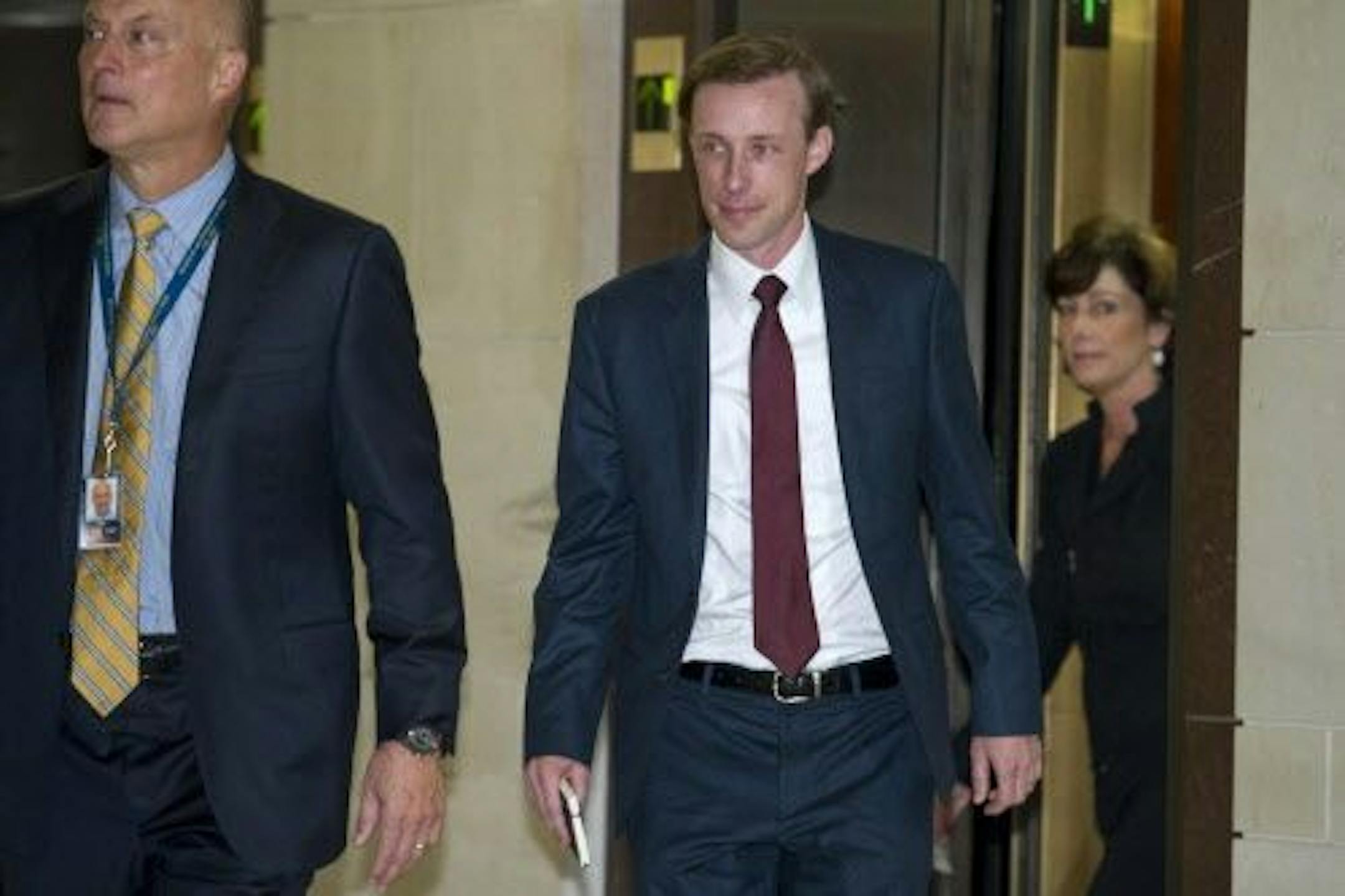 Former Hillary Clinton aide Jake Sullivan, center, arrives to be interviewed before a House panel on the Benghazi investigation Friday.