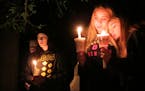 Community members attend a candlelight vigil at Stewart Park for those killed during a shooting at Umpqua Community College in Roseburg, Ore., Thursda