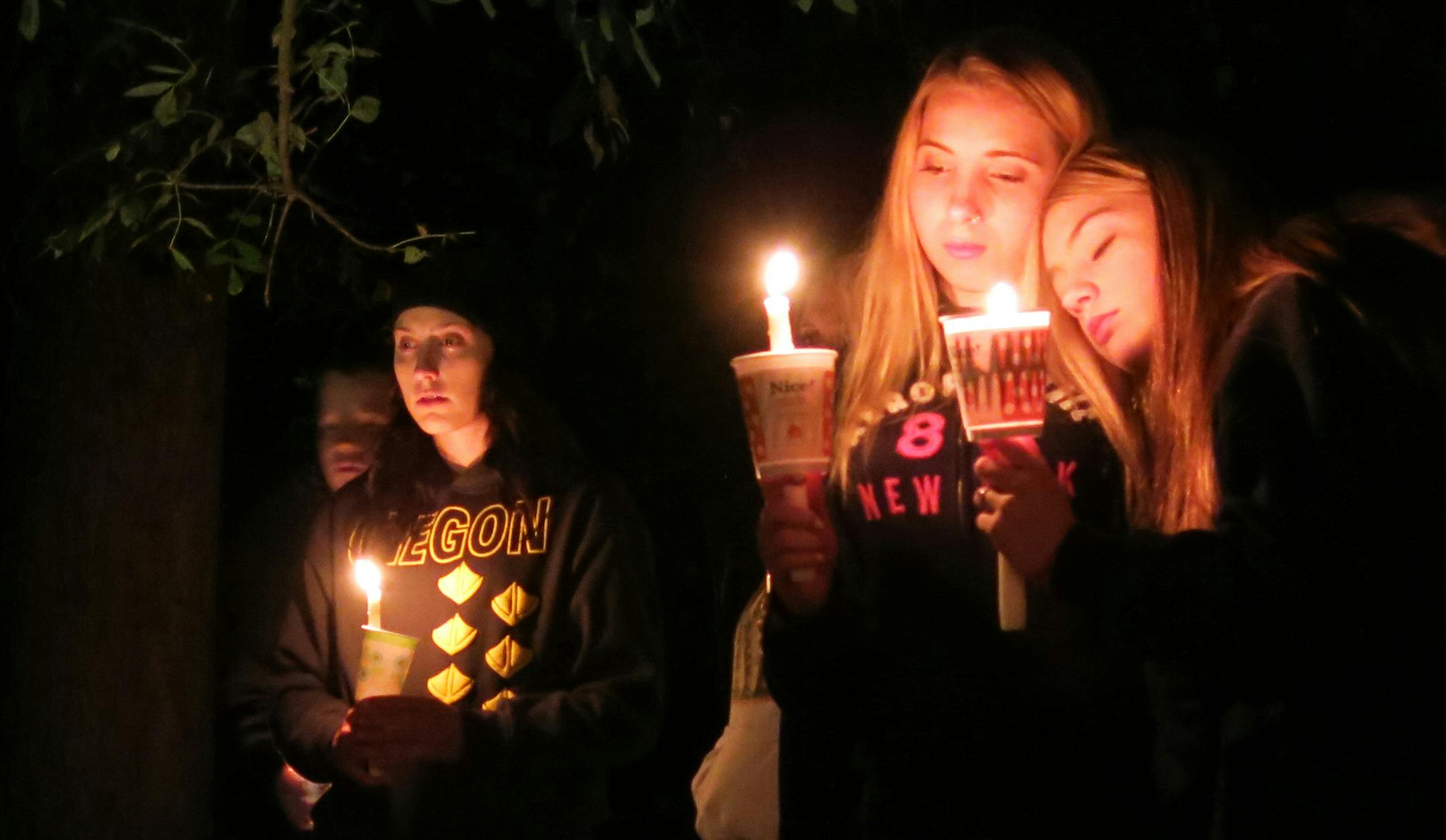Community members attend a candlelight vigil at Stewart Park for those killed during a shooting at Umpqua Community College in Roseburg, Ore., Thursday, Oct. 1, 2015. (AP Photo/Gosia Wozniacka) ORG XMIT: MIN2015100212050022