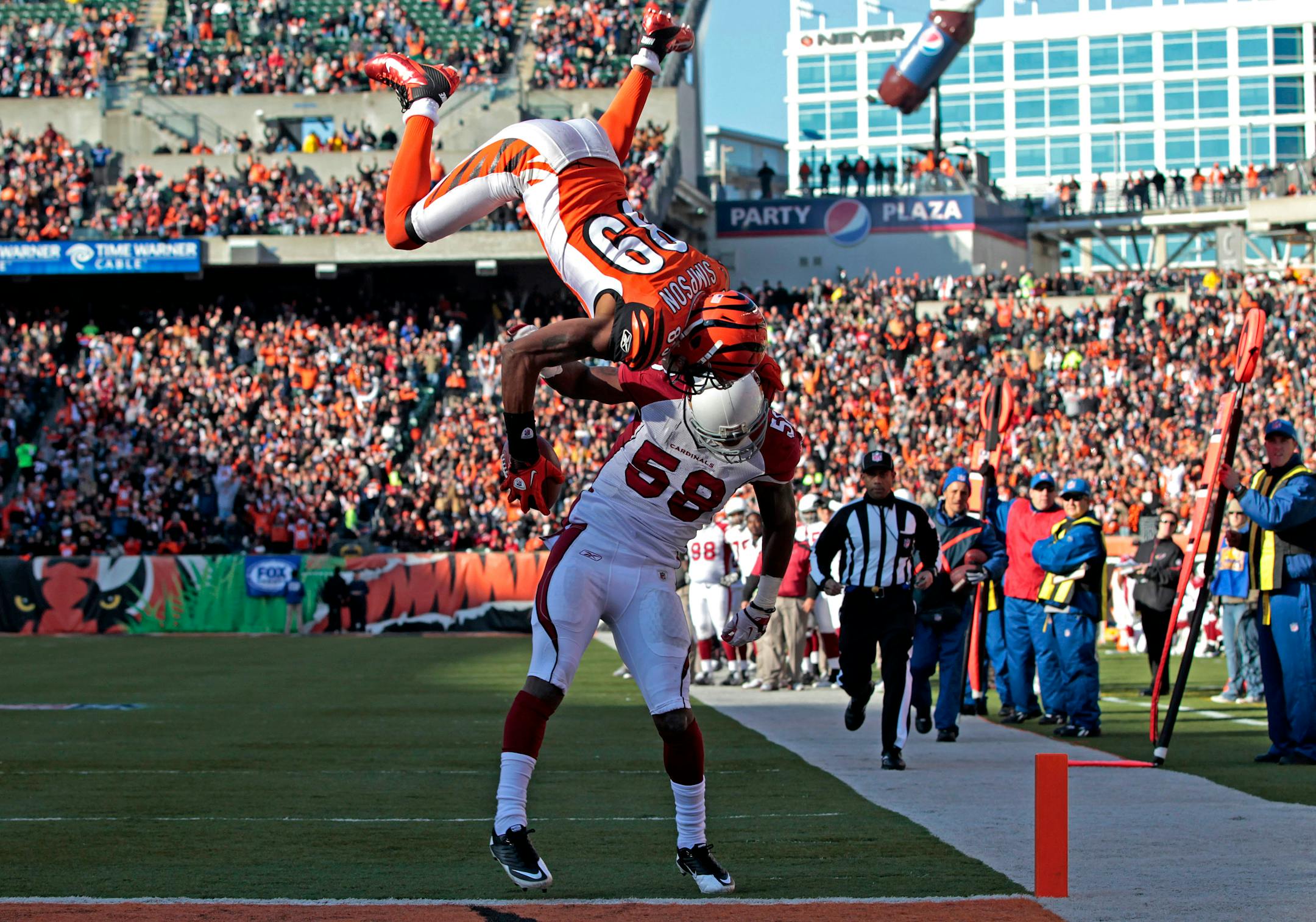 Cincinnati Bengals wide receiver Jerome Simpson (89) flips over Arizona Cardinals linebacker Daryl Washington (58) for a touchdown in the first half of an NFL football game, Saturday, Dec. 24, 2011, in Cincinnati. (AP Photo/Darron Cummings)