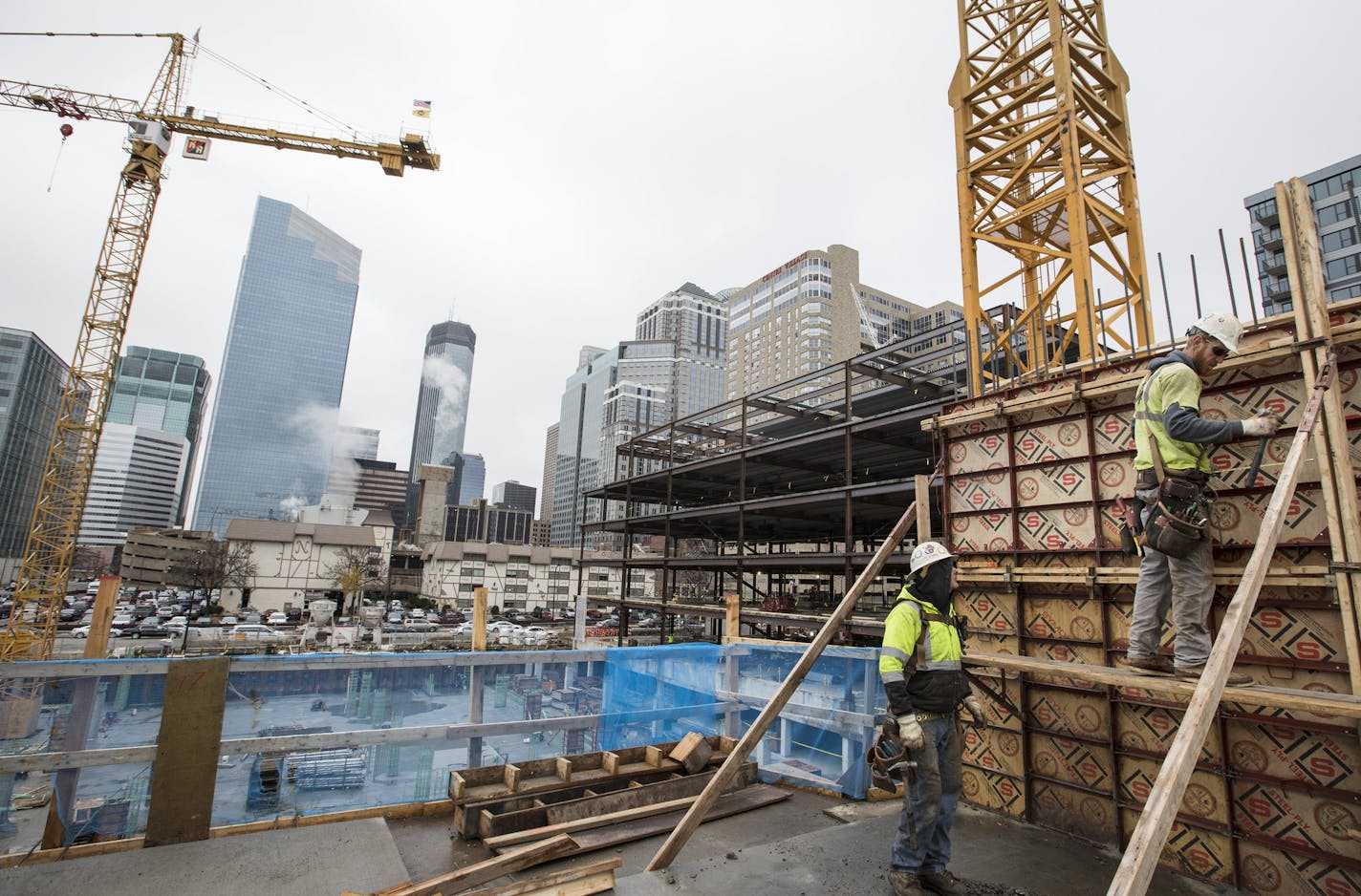 Carpenters work on fine tuning the levels of the elevator shaft walls of a new 17-story residential tower located at Portland Ave. and 9th Street in downtown Minneapolis. ] (Leila Navidi/Star Tribune) leila.navidi@startribune.com BACKGROUND INFORMATION: Construction on a new 17-story residential tower located at Portland Ave. and 9th Street in downtown Minneapolis on Wednesday, October 26, 2016. The 306-unit apartment residence has been named &#x201c;H.Q.&#x201d; Owned by Kraus-Anderson, H.Q. is