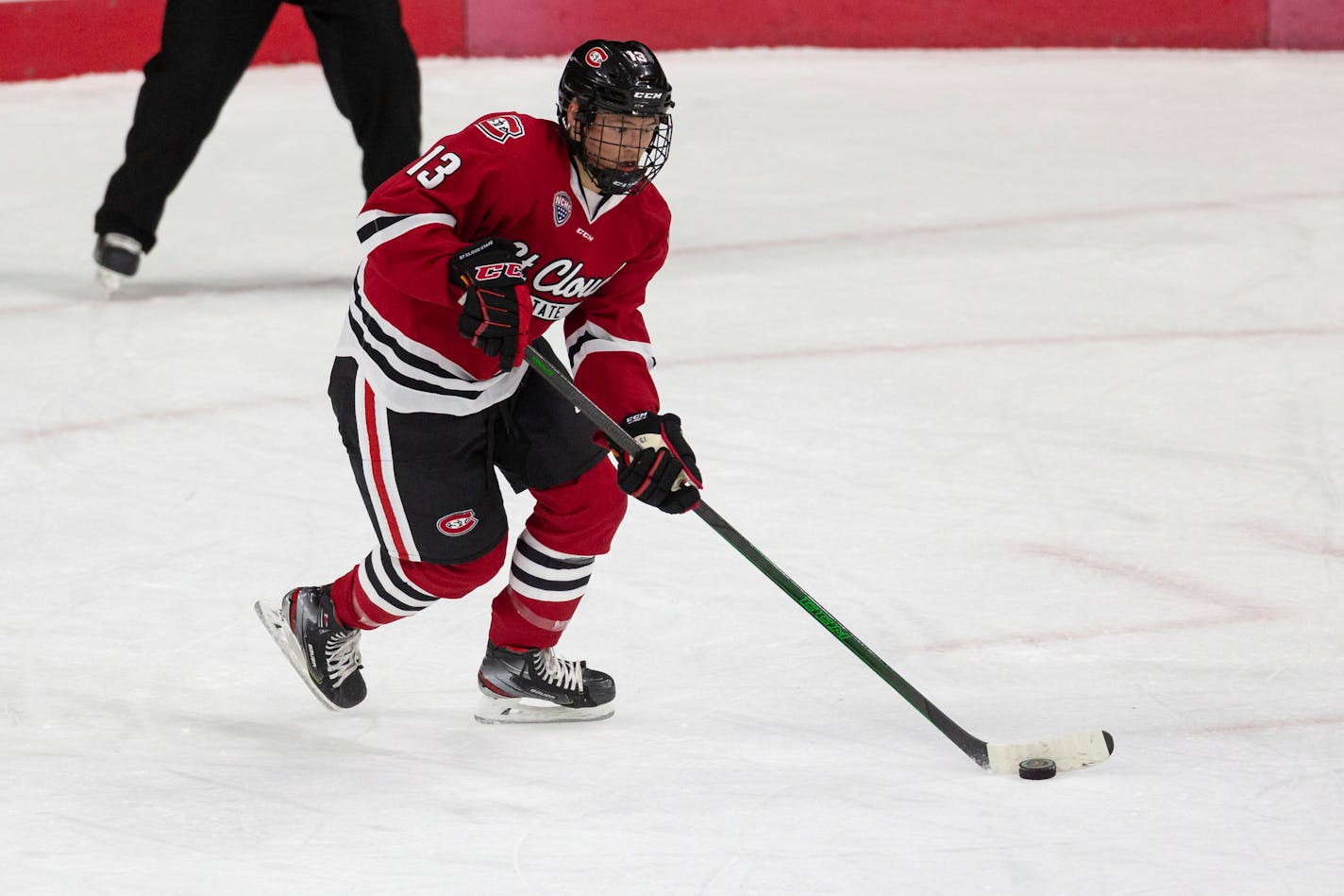 St. Cloud State forward Jami Krannila (13) moving the puck down the ice against the Western Michigan during an NCAA hockey game on Tuesday, Dec. 1, 2020, in Omaha, Neb. (AP Photo/John Peterson)