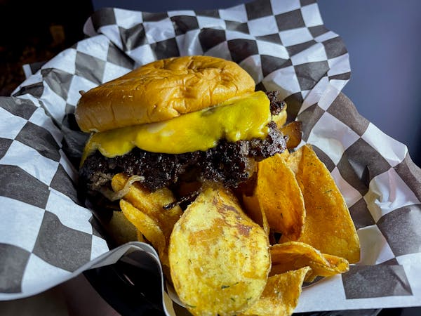 A new smash burger comes with lacy beef edges and a pile of housemade chips at Bina's.