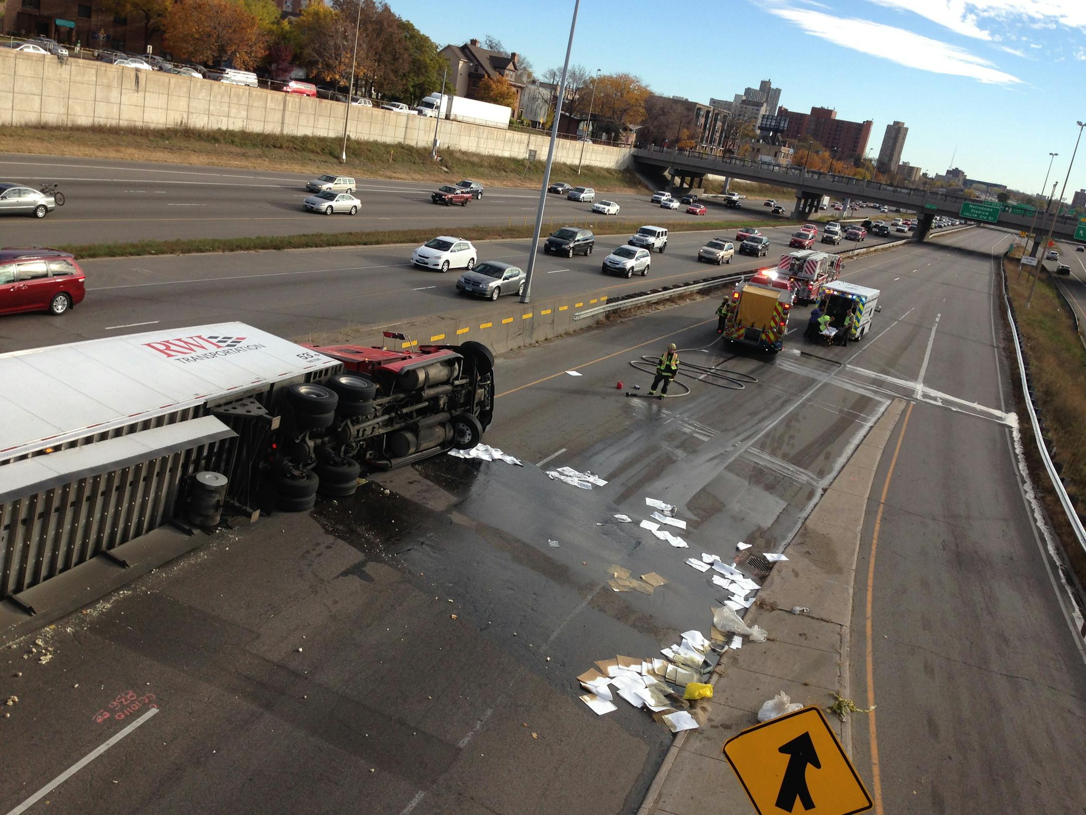 A semitrailer truck lay on its side after rolling over on northbound I-35W on the south edge of downtown Minneapolis on Saturday, Oct. 25, 2014.