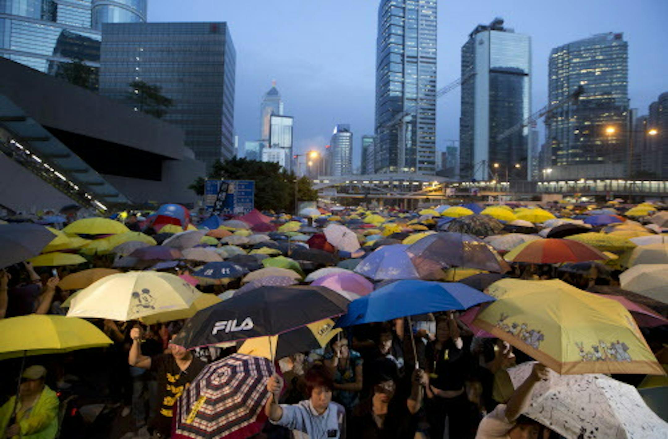 Pro-democracy protesters raise umbrellas at a rally in the occupied areas outside government headquarters in Hong Kong's Admiralty Tuesday, Oct. 28, 2014. Pro-democracy protests in Hong Kong stretched into a fourth week, as student leaders pushing for a greater say in choosing the territory's chief executive met with government officials but agreed on little. (AP Photo/Kin Cheung)