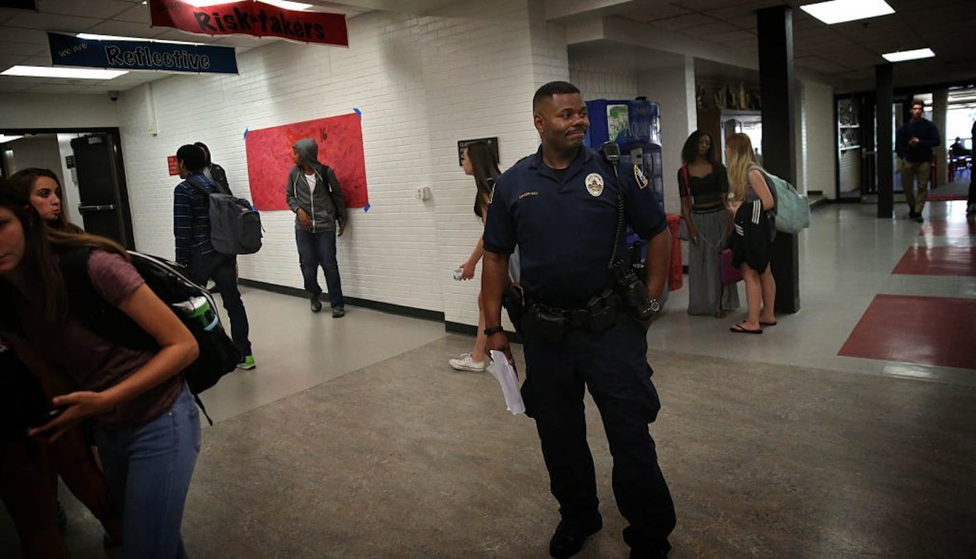 Cortez Hull, school resource officer (SRO) at Highland Park High School in St. Paul, monitored the hallways as classes let out for the day.