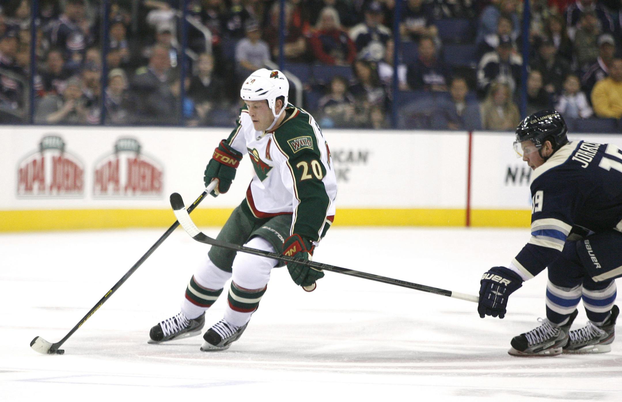 Minnesota Wild's Ryan Suter (20) brushes away the stick of Columbus Blue Jackets' Ryan Johansen (19) in the first period of an NHL hockey game on Sunday, April 7, 2013, in Columbus, Ohio. (AP Photo/Mike Munden)