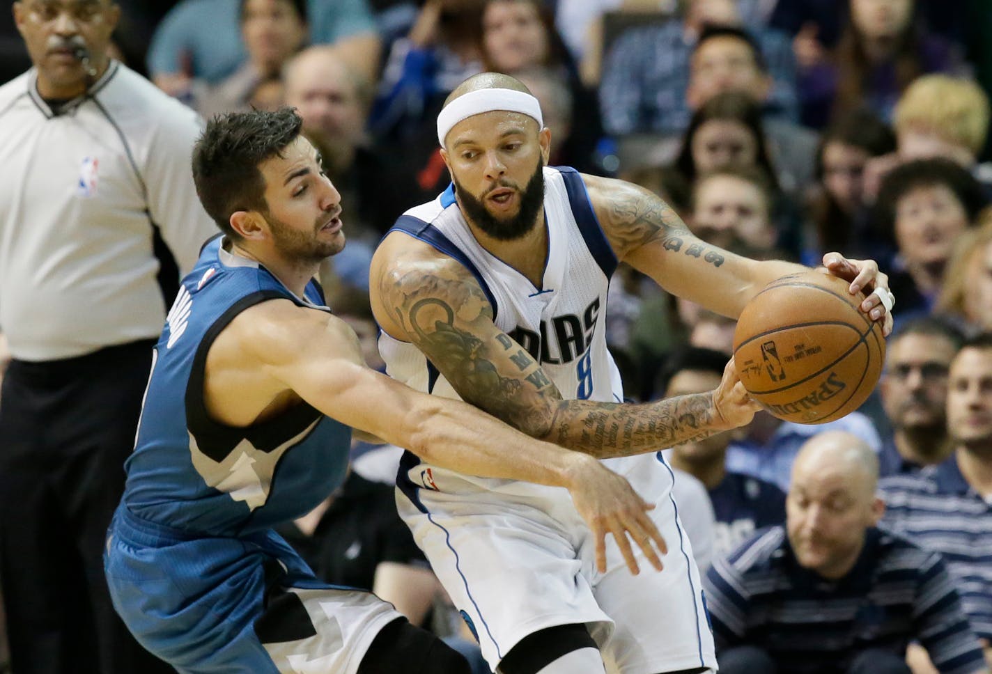 Minnesota Timberwolves guard Ricky Rubio (9) reaches in against Dallas Mavericks guard Deron Williams (8) during the first half of an NBA basketball game Sunday, Feb. 28, 2016, in Dallas. (AP Photo/LM Otero)