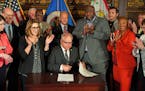 Gov. Tim Walz conducts a ceremonial signing of the racial covenants bill passed by the Legislature that will allow individual homeowners to register t