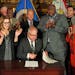 Gov. Tim Walz conducts a ceremonial signing of the racial covenants bill passed by the Legislature that will allow individual homeowners to register t