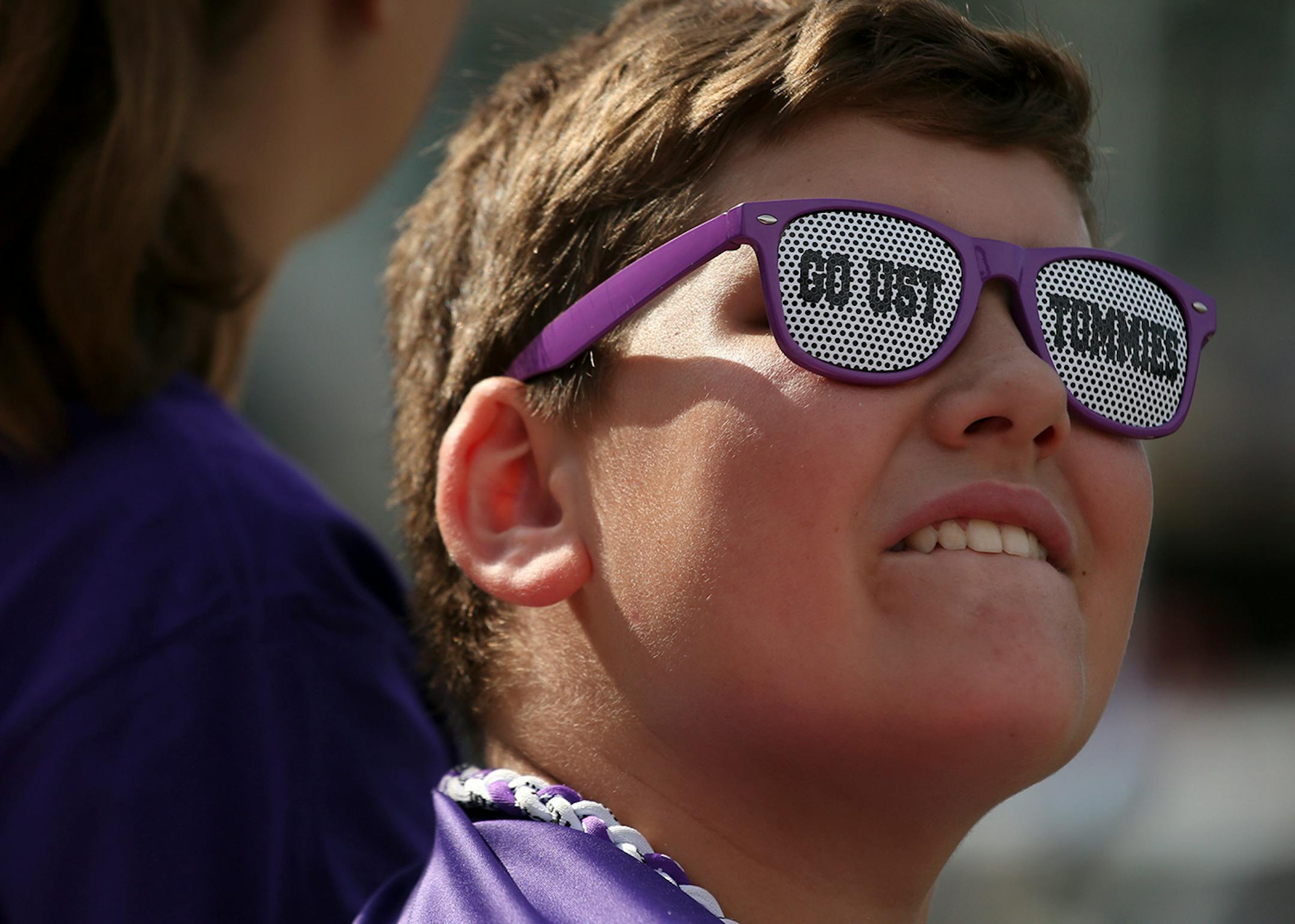University of St. Thomas fan Harley Hohenstein, 7, of East Bethel, Minn. watched from the stands as St. John's University players warmed up prior to Saturday's game at Target Field.
