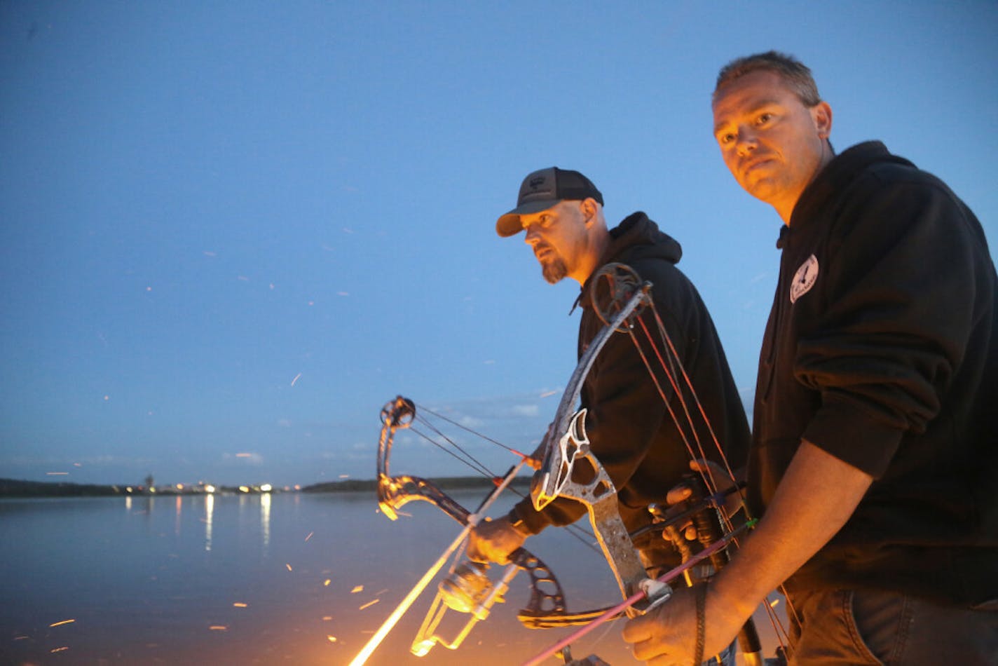 Kirschbaum and Sassen watch the shallow water of a Mississippi River Bay closely, looking for carp and other "rough'' fish.