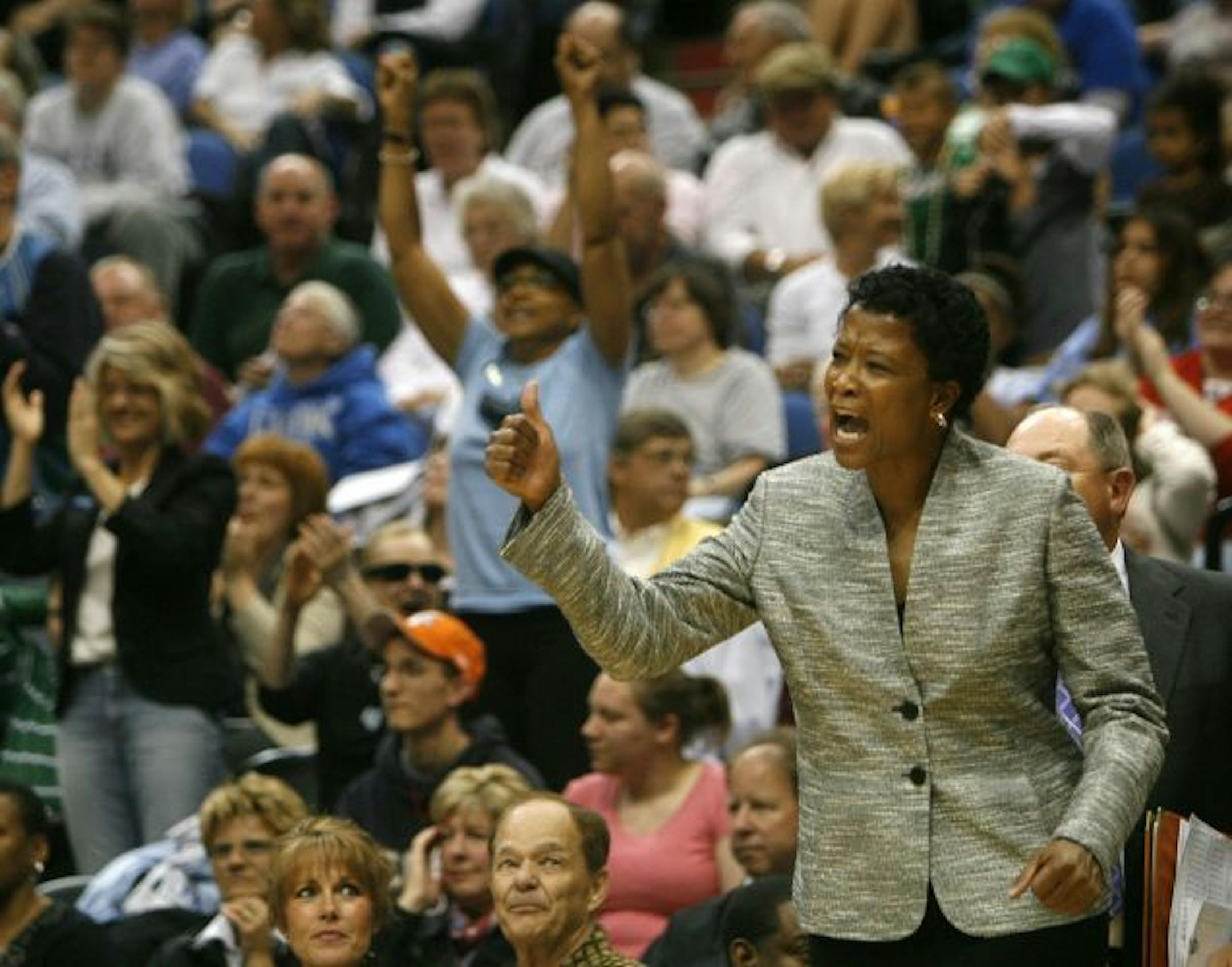 New Minnesota Lynx head coach Jen Gillom likes what she see against the Chicago Sky during 2nd quarter action of the Lynx season opener at the Target Center.