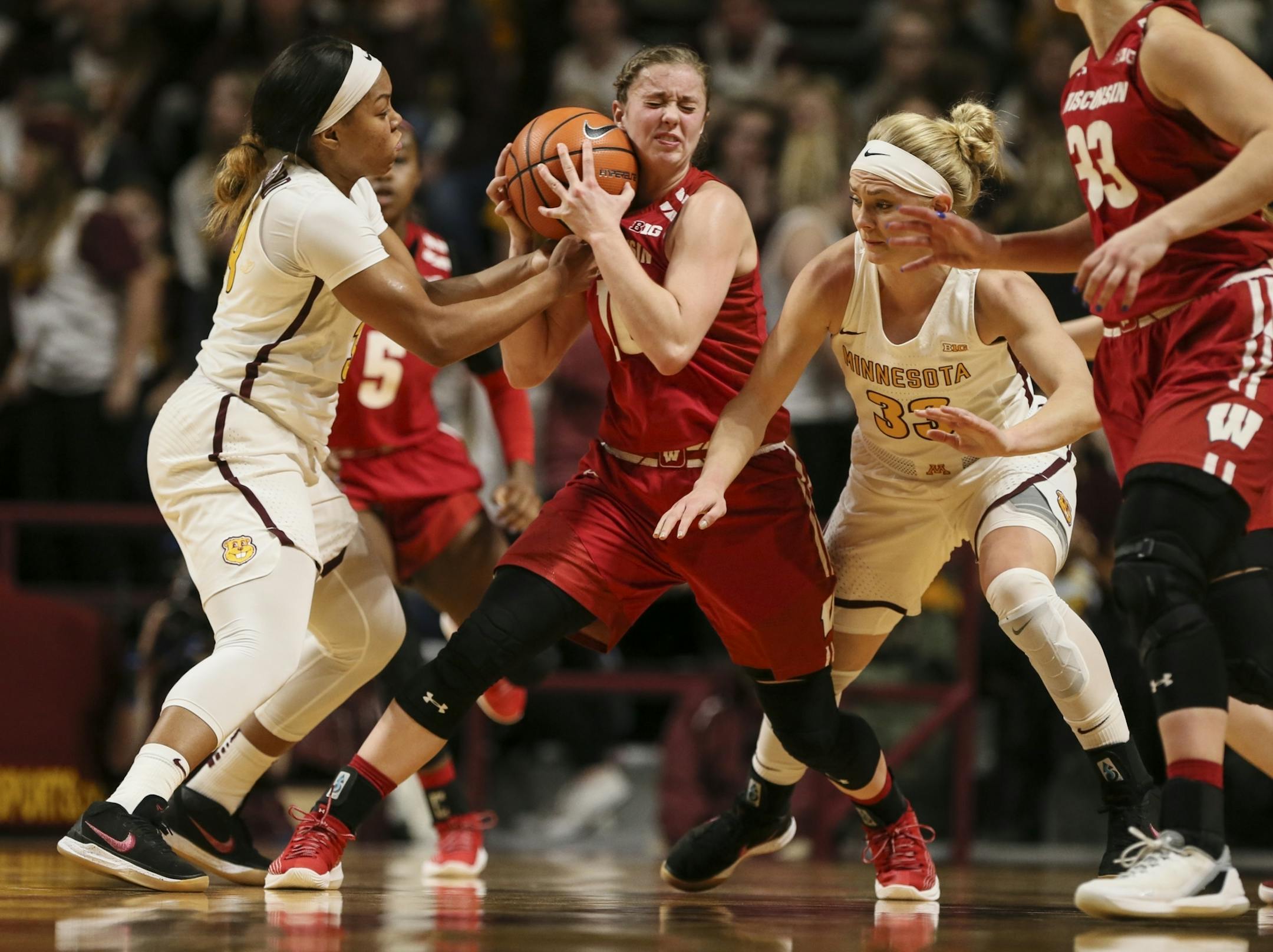 Gophers guards Gadiva Hubbard (34) and Carlie Wagner (33) trapped Wisconsin guard Kendra Van Leeuwen in a game last month.