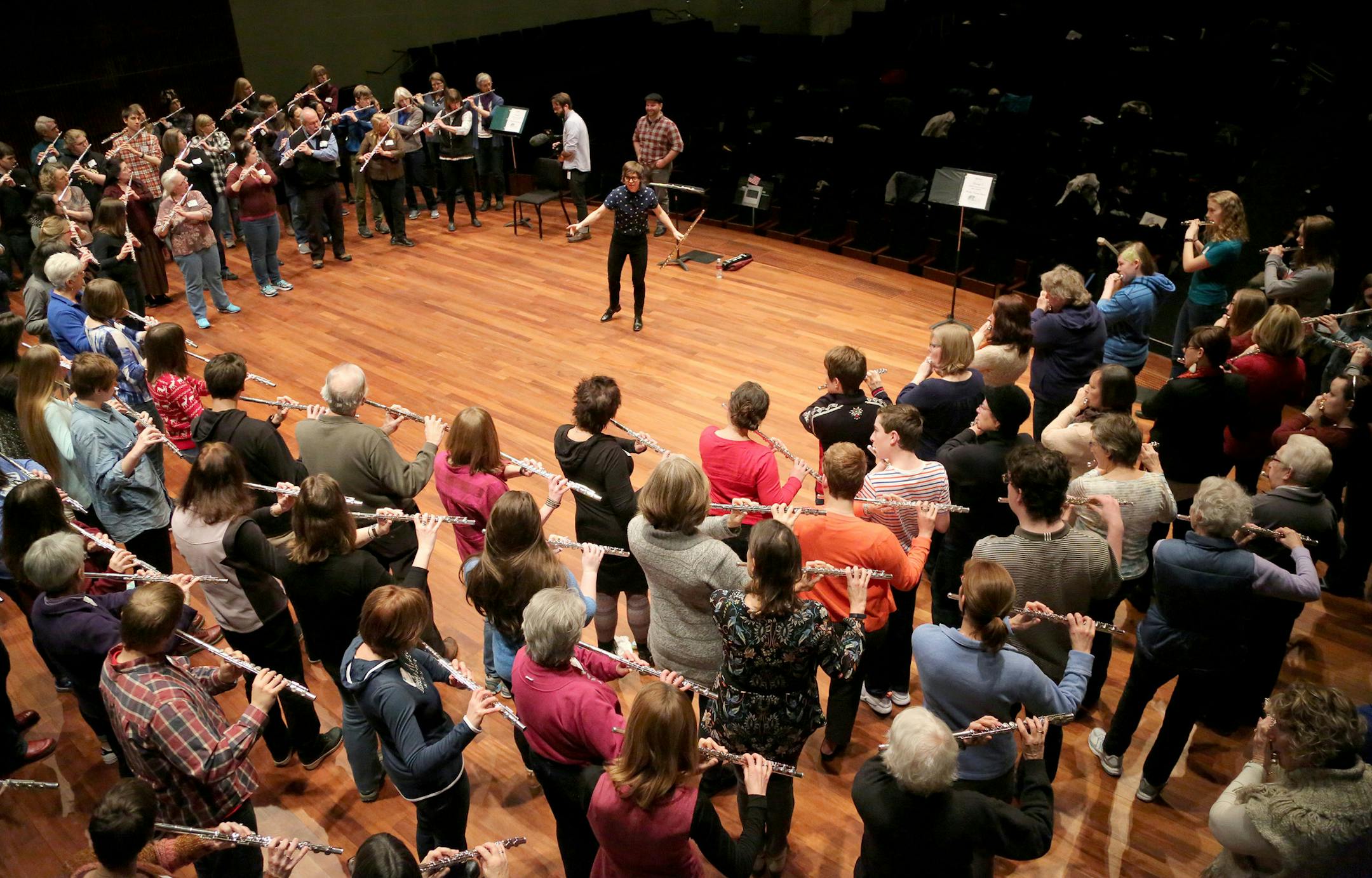 Flute players young and old, ranging in ability from newbies to masters, filed into Ordway Concert Hall on Saturday morning for an unusual rehearsal. Superstar flutist Claire Chase, standing at center above, will lead this “flute force” Wednesday night in a performance with the St. Paul Chamber Orchestra.