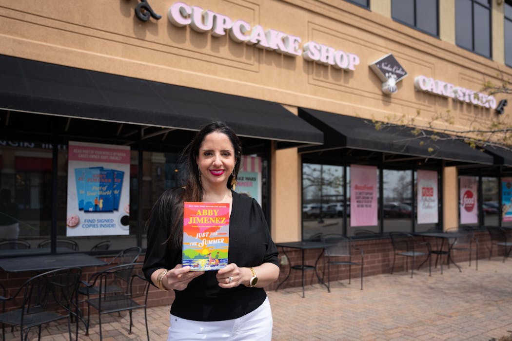 Abby Jimenez, bestselling romance author and cupcake boss, stands for a portrait at Nadia Cakes in Maple Grove on April 30.