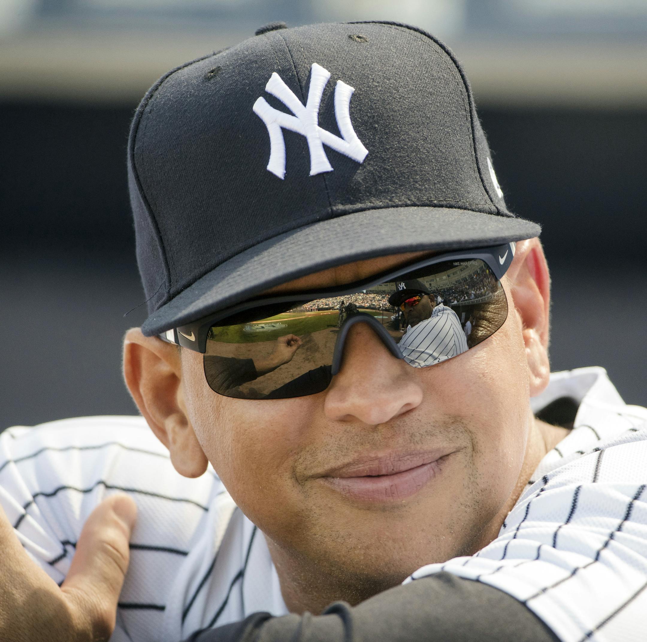 FILE - In this Friday, Feb. 24, 2017, file photo, New York Yankees special advisor Alex Rodriguez speaks with CC Sabathia, who reflected in his sunglasses, ahead of a spring training baseball game against the Philadelphia Phillies in Tampa, Fla. Back at spring training with the New York Yankees as a guest instructor, Alex Rodriguez watched part of an exhibition game against the Baltimore Orioles on Saturday, March 18, 2017 in a suite with singer-actress Jennifer Lopez. (AP Photo/Matt Rourke, Fil