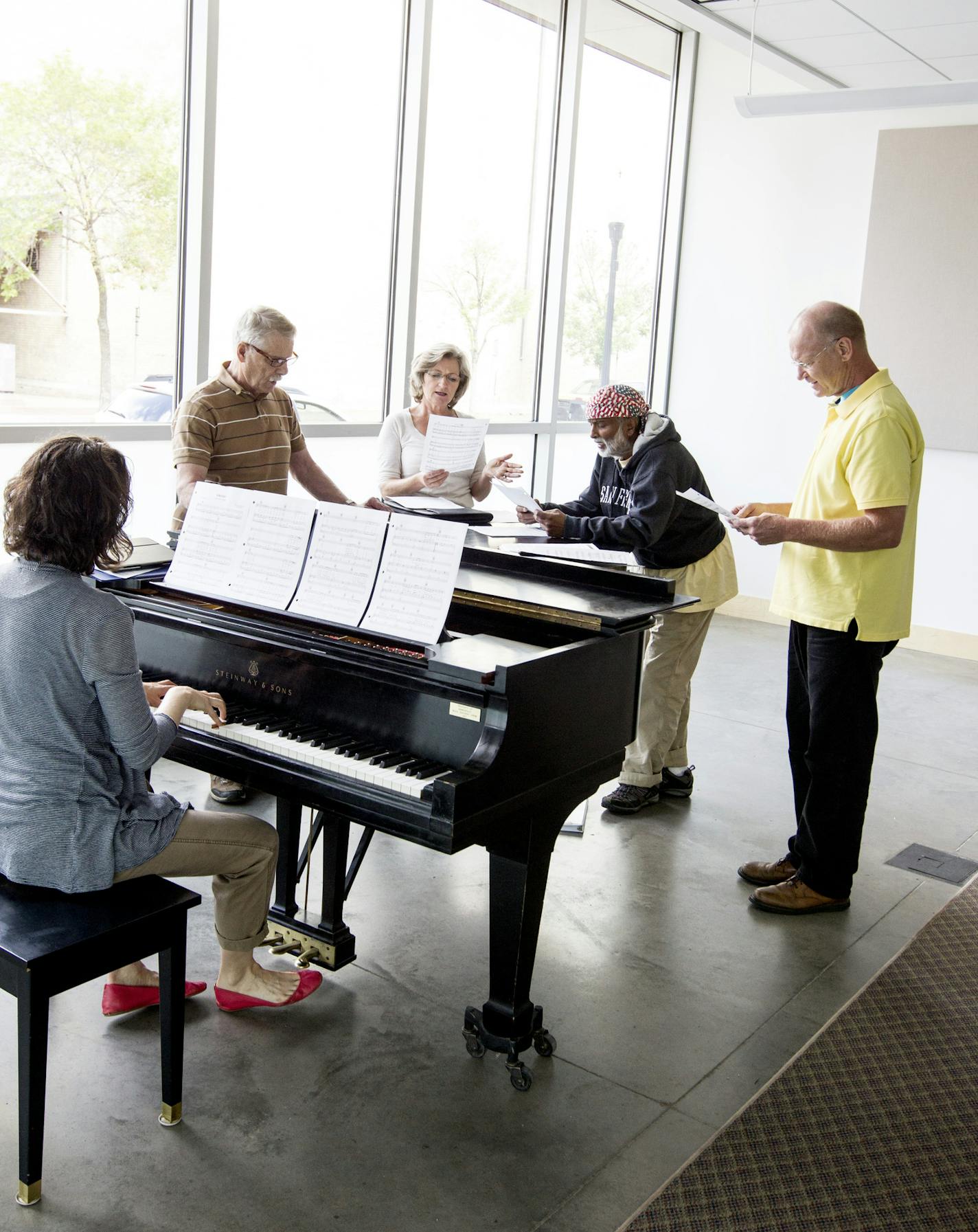 Standing left to right, Charles Reinhart, Cindy Dittmer, Krishna Seshan, and Gary Anderson work on a song in Andrea Leap's Singing Basics class at MacPhail Center for Music in Minneapolis July 15, 2014. (Courtney Perry/Special to the Star Tribune)