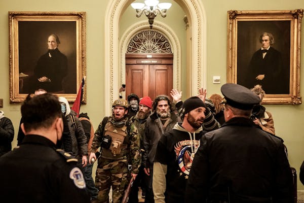 Robert Gieswein, left, in military garb, and Dominic Pezzola, center right, with a gray beard, confronted Capitol Police officers at the U.S. Capitol 