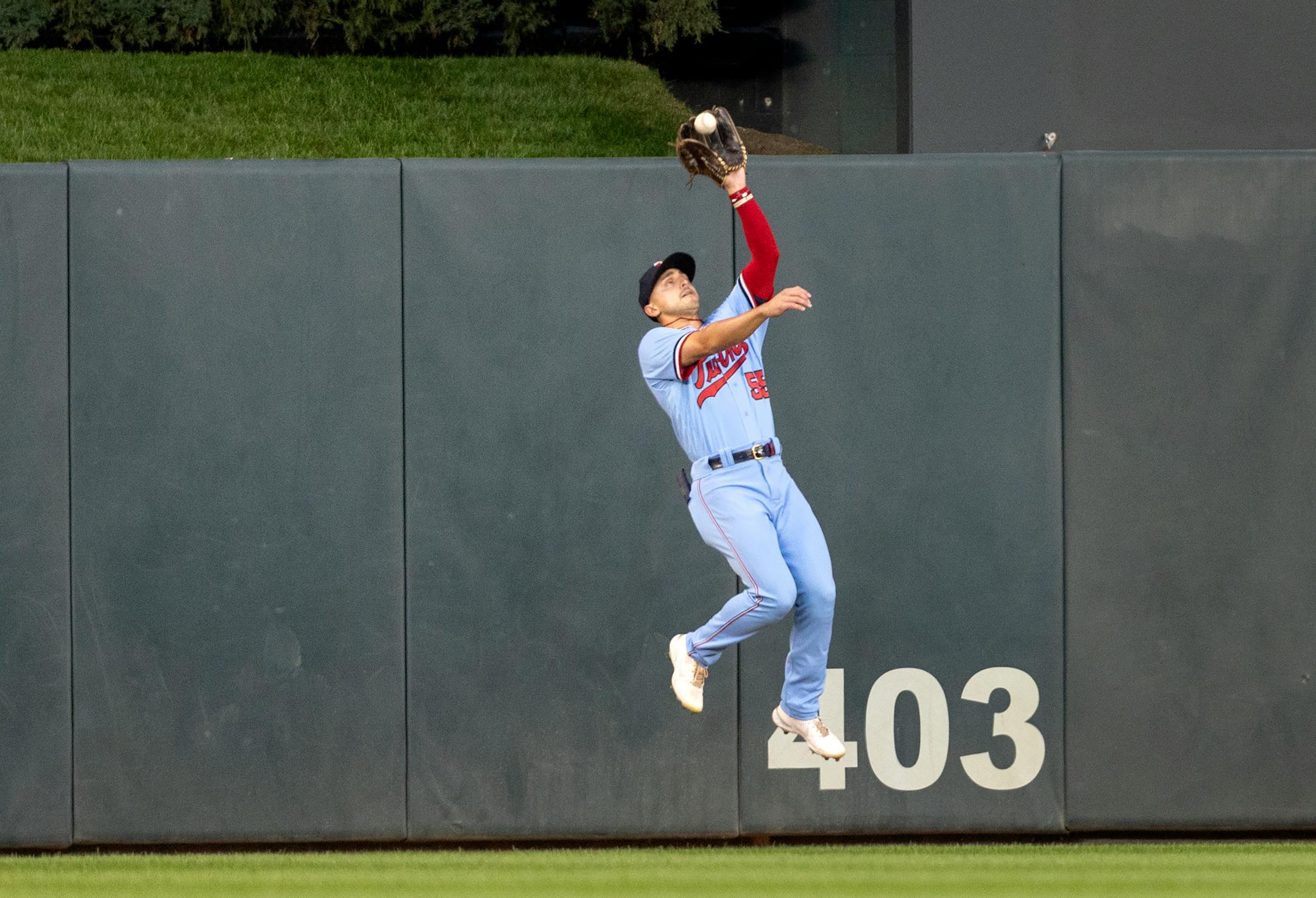 Minnesota Twins centerfielder Mark Contreras catches a deep fly ball in the first inning.