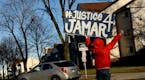 A protestor waved a "Justice 4 Jamar" banner at traffic turning onto Plymouth Avenue Friday afternoon. ] (AARON LAVINSKY/STAR TRIBUNE) aaron.lavinsky@