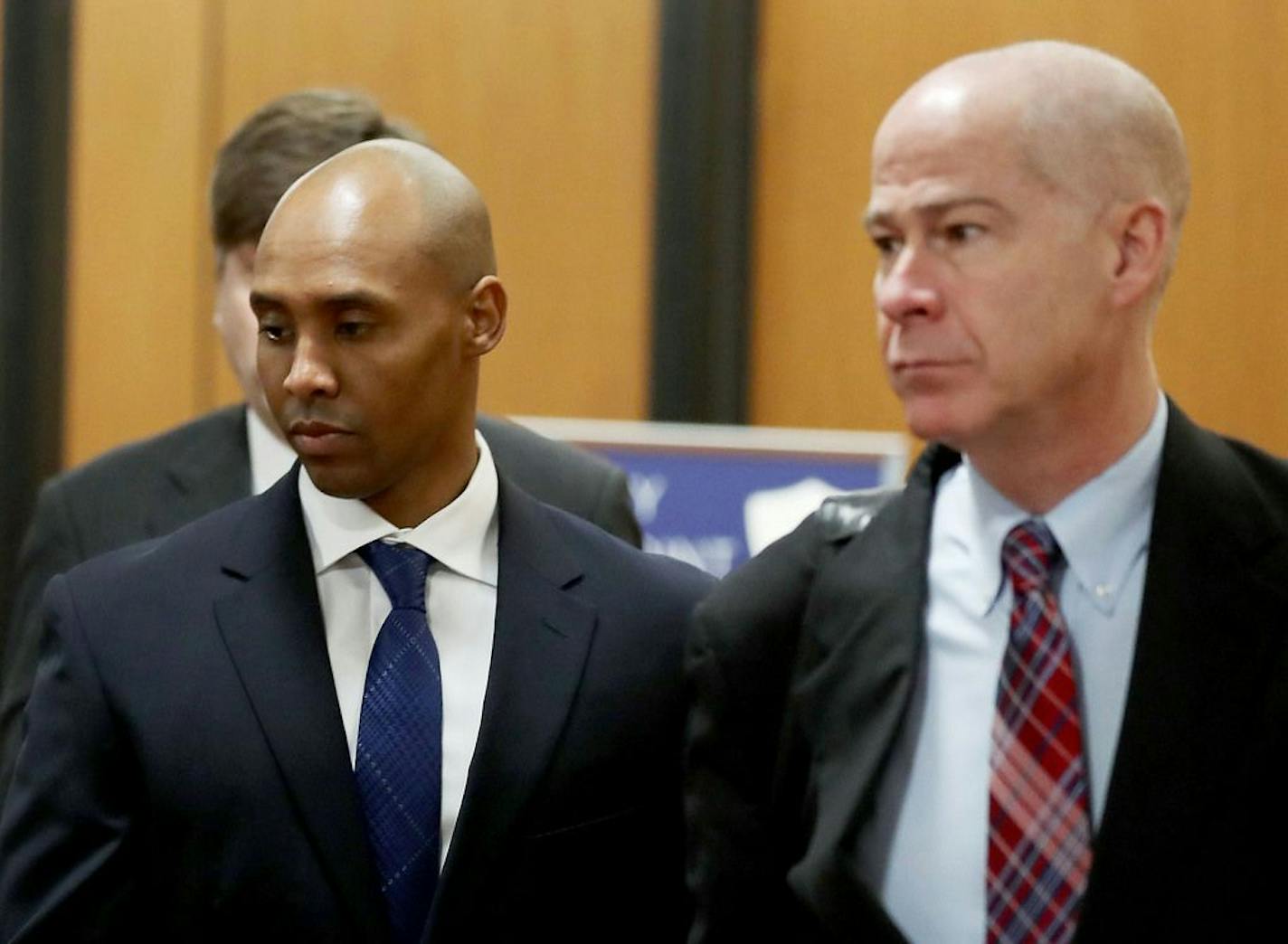 Former Minneapolis police officer Mohamed Noor, center, is accompanied by his attorneys Peter Wold, not pictured, and Thomas Plunkett, right, as he walks towards the Hennepin County Government Center for opening arguments of his trial Tuesday, April 9, 2019, in Minneapolis, MN.