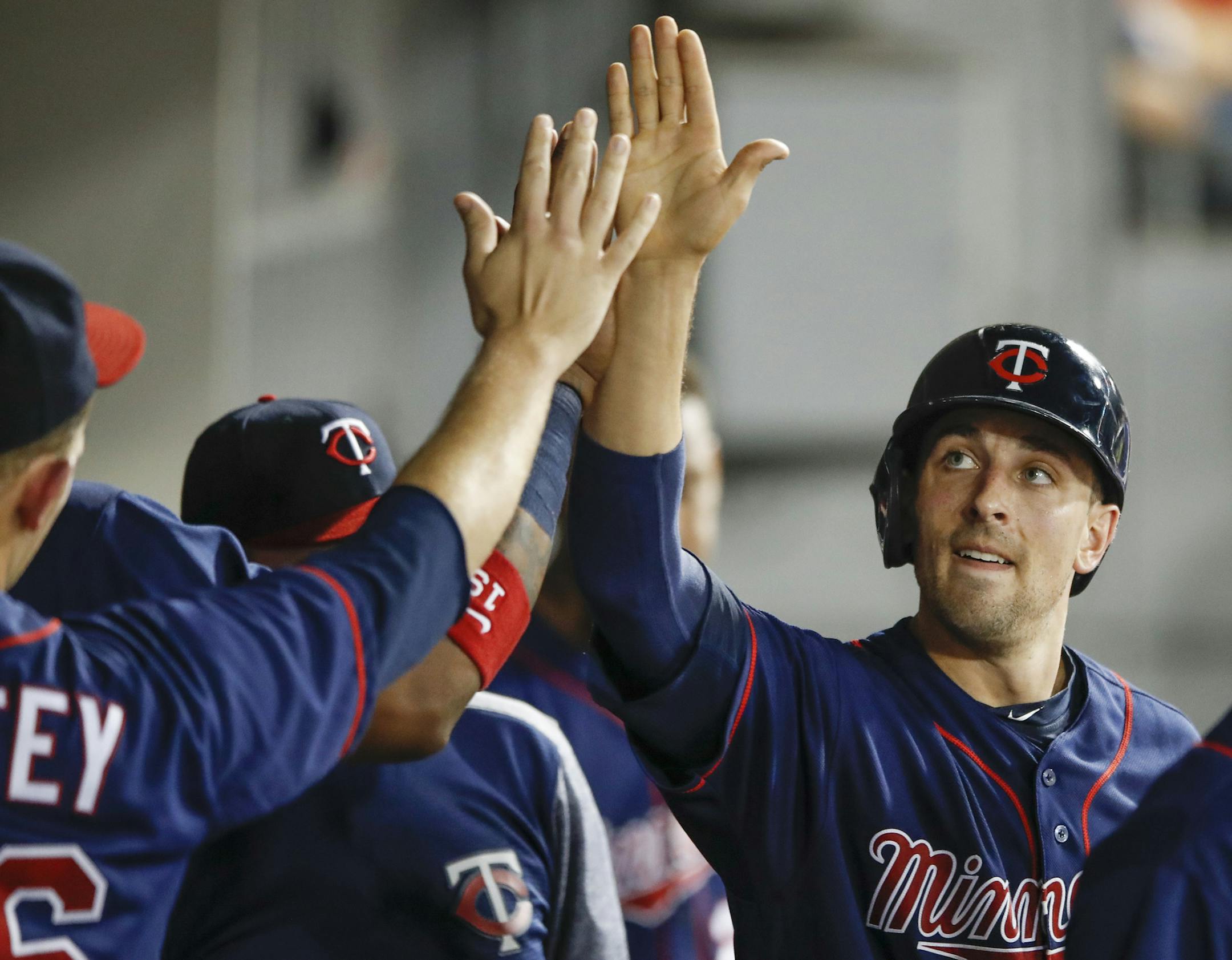 Minnesota Twins' Jason Castro celebrates with teammates after scoring on a RBI-single hit by Chris Gimenez off Chicago White Sox' Brad Goldberg during the eighth inning of game two of a baseball doubleheader, Monday, Aug. 21, 2017, in Chicago. (AP Photo/Kamil Krzaczynski)