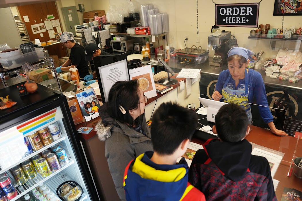 Junko Kumamoto took orders during the lunch rush at JK's Table, a Japanese restaurant she owns with her husband, Hiroshi, on Friday in Edina.