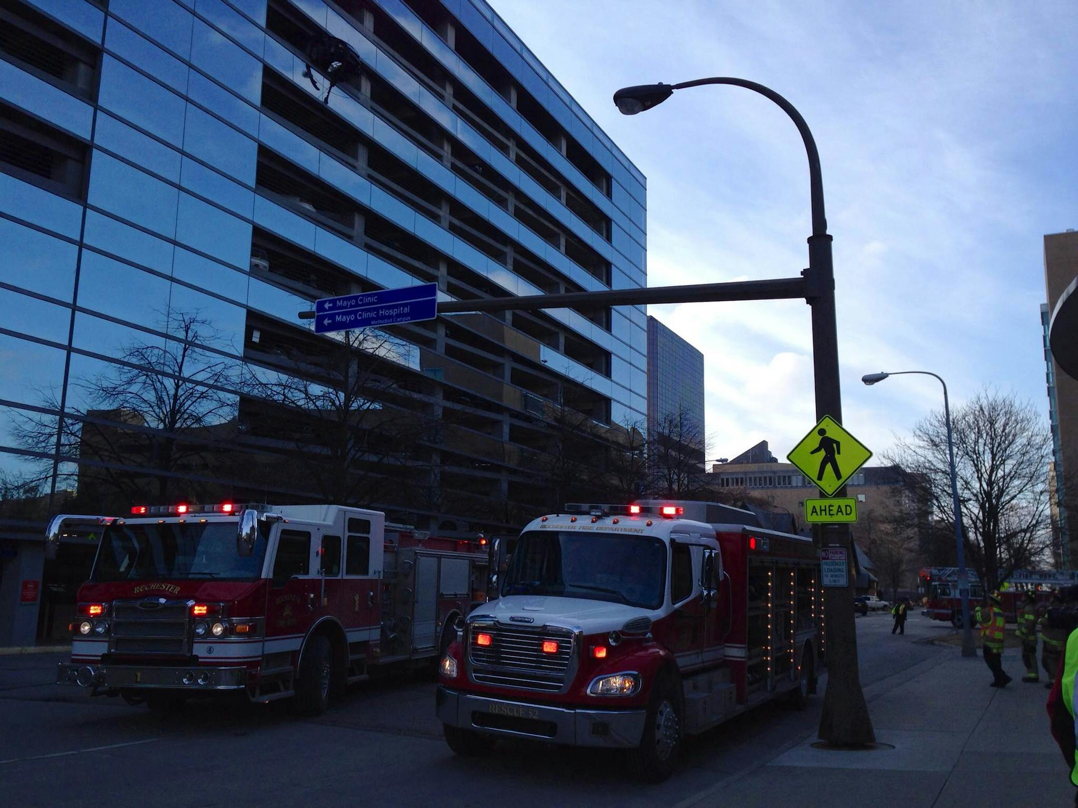 A car dangled Friday morning from the upper levels of a Mayo Clinic parking ramp in Rochester, Minn.