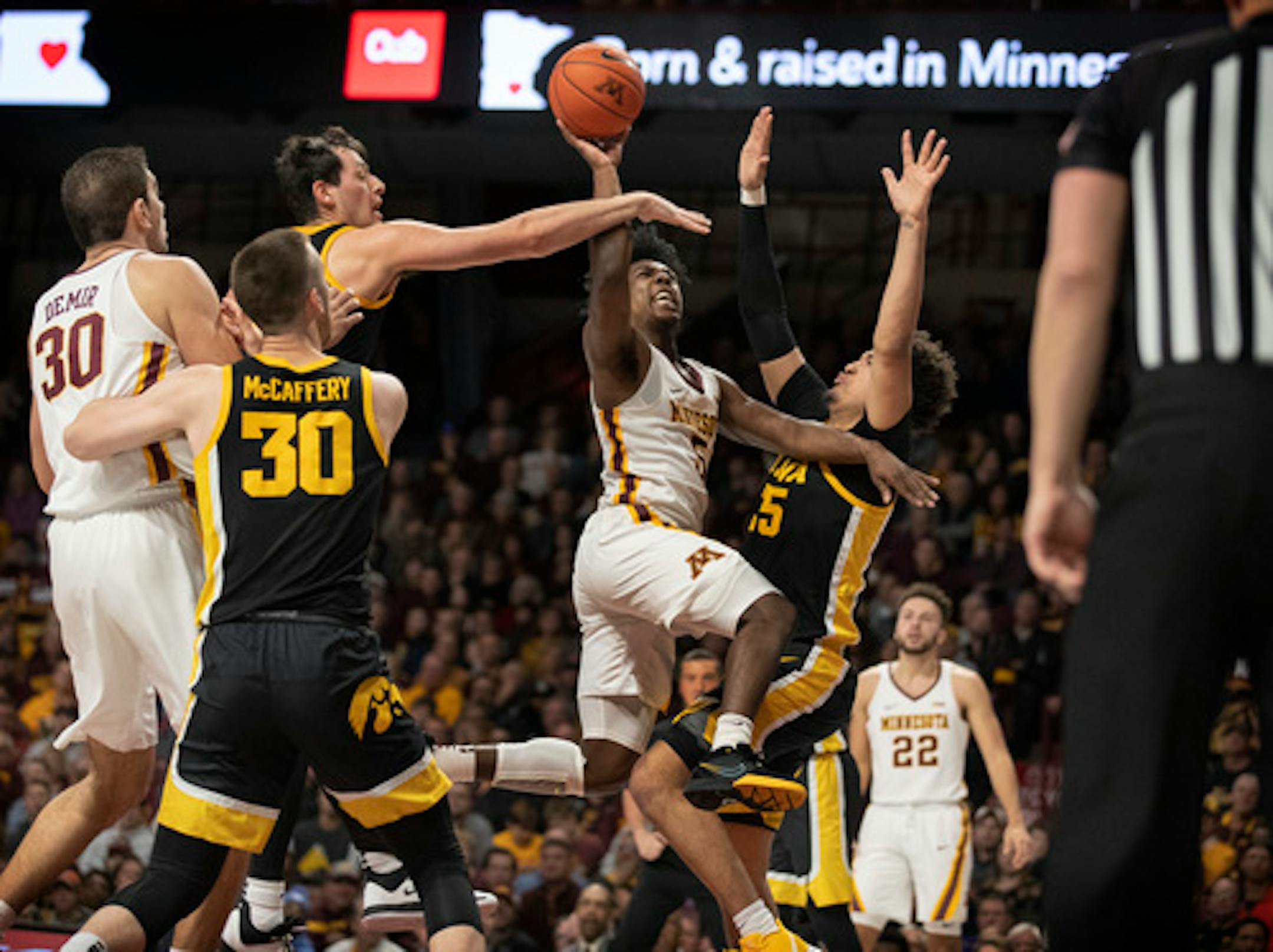 Minnesota Golden Gophers guard Marcus Carr (5) drove to the basket on Iowa Hawkeyes forward Cordell Pemsl (35).] Jerry Holt  •Jerry.Holt@startribune.com