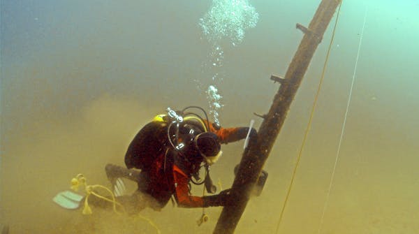 In this photo made June 16, 2013, and provided by Great Lakes Exploation Group, diver Jim Nowka of Great Lakes Exploration Group inspects a wooden bea
